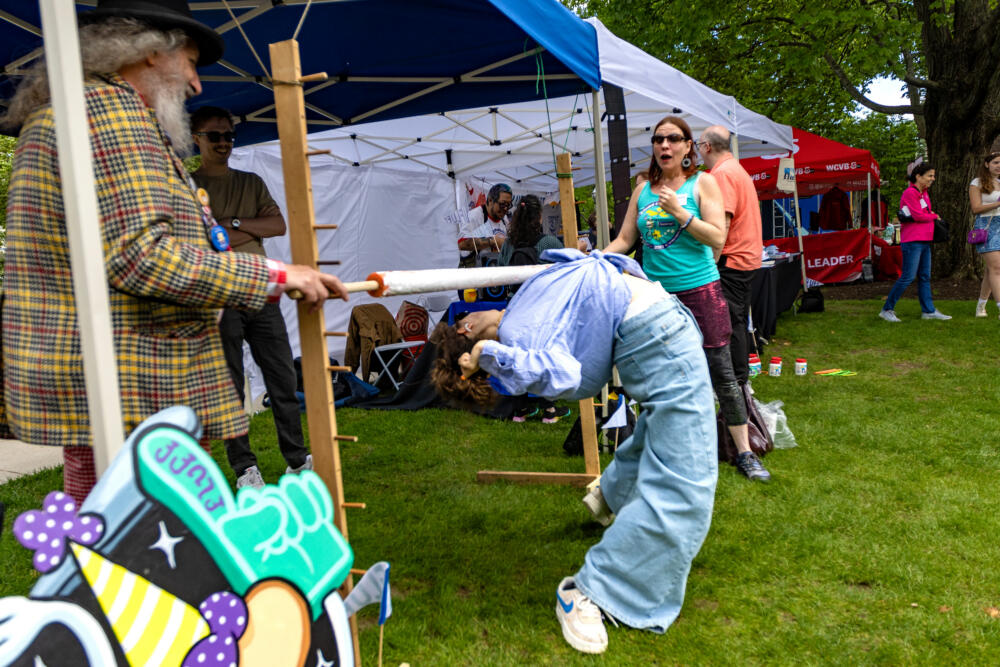 People play limbo at the Union Square Streets tent at the Street Fair at the WBUR Festival in 2025. (Jesse Costa/WBUR)