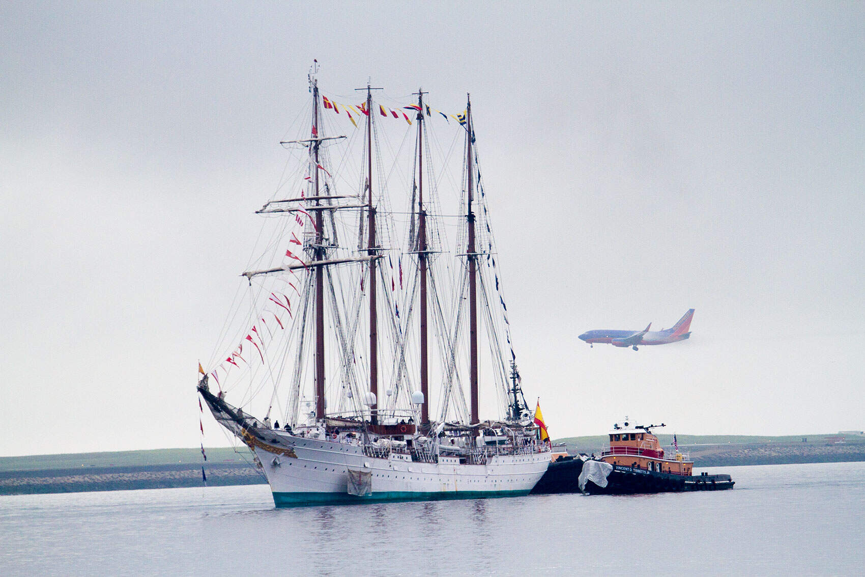 The Spanish Tall Ship Juan Sebastian de Elcano is escorted into Boston Harbor. (Jesse Costa/WBUR)