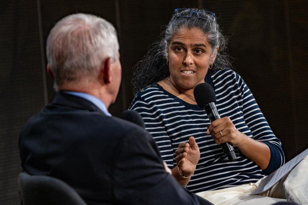 On Point host Meghna Chakrabarti on stage with Dr. Anthony Fauci during the Edward R. Murrow Society Appreciation Event at CitySpace. (Jesse Costa/WBUR)
