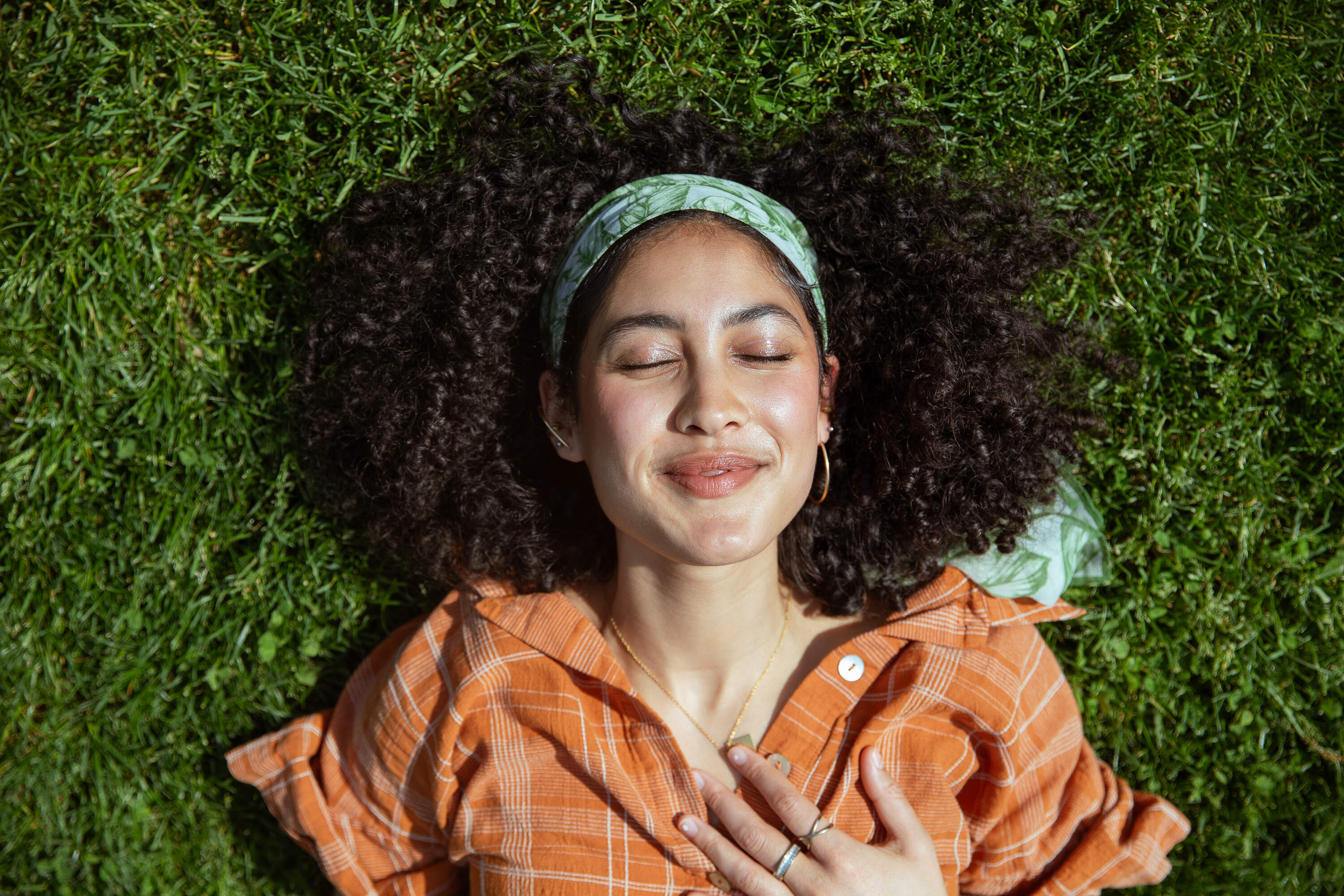 Boston singer-songwriter riah poses in Amory Park in Brookline, near her alma mater Boston University. From 22 finalists, local fans voted for riah as the 2026 Massachusetts Tiny Desk Fan Favorite. (Artemisia Luk/WBUR)