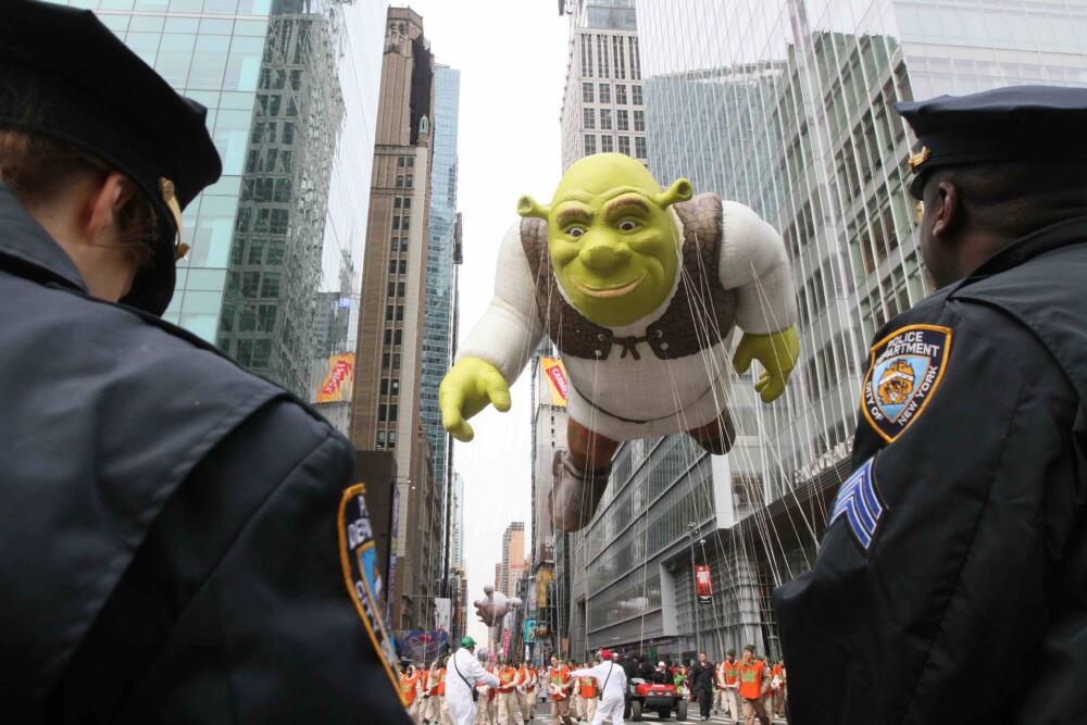 Members of the New York Police Department stand by as the Shrek balloon makes it's way across 42nd Street during the Macy's Thanksgiving Day Parade on Thursday, Nov. 25, 2010 in New York. (Tina Fineberg/AP)