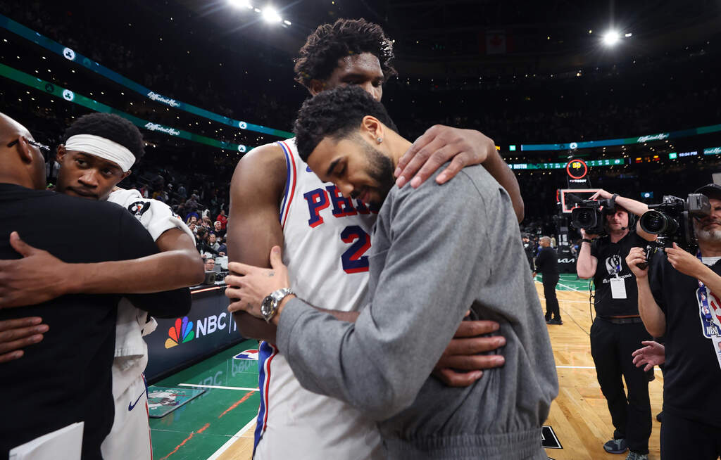 Boston Celtics' Jayson Tatum (right) and Philadelphia 76ers' Joel Embiid (left) embrace following Philadelphia's victory in Game 7 in a first-round NBA basketball playoffs series, Saturday, May 2, 2026 in Boston. (AP Photo/Jim Davis)