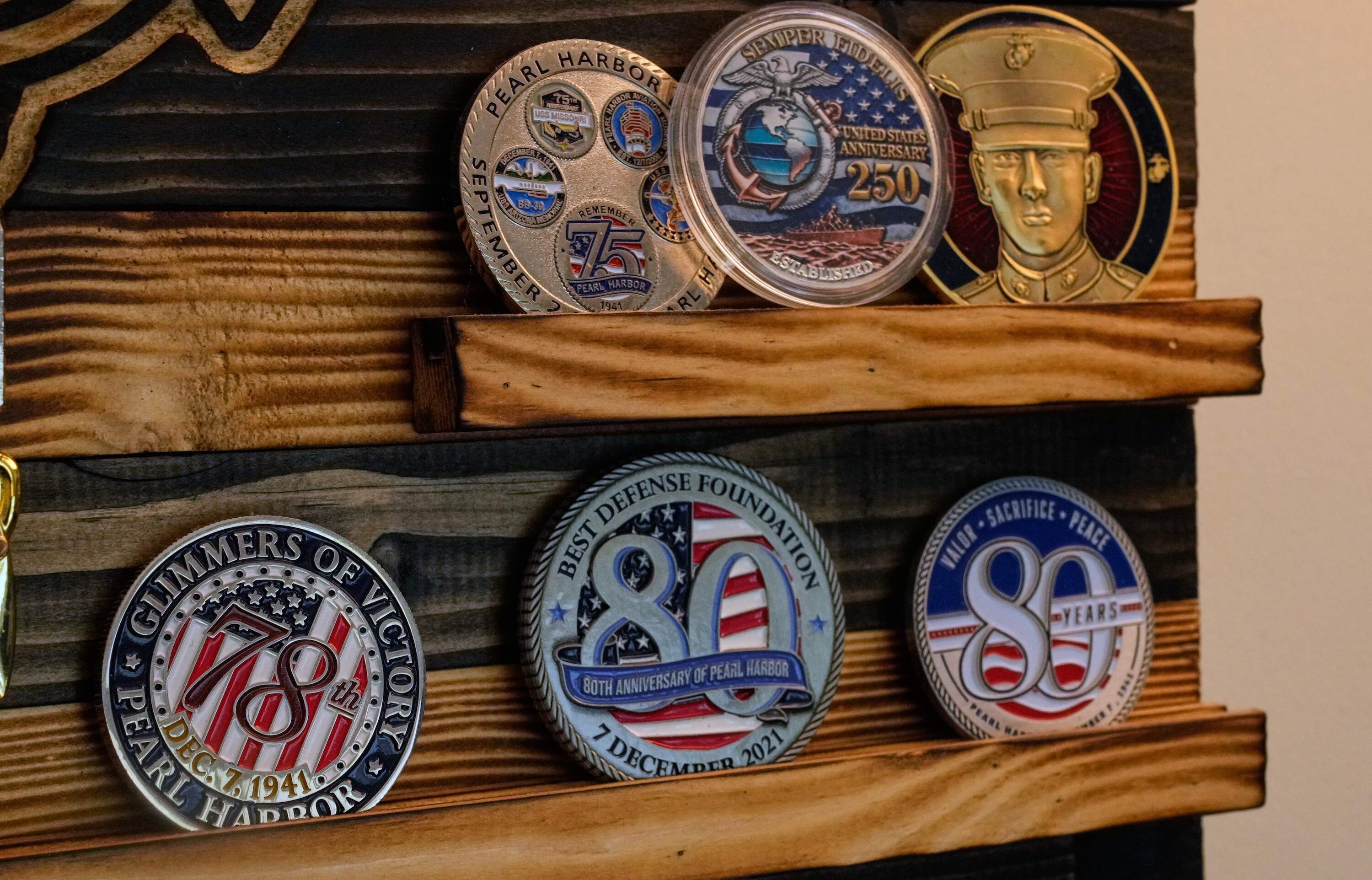 A collection of challenge coins is on display in Pearl Harbor survivor Freeman K. Johnson's home in Centerville, Mass. (Charles Krupa/AP)