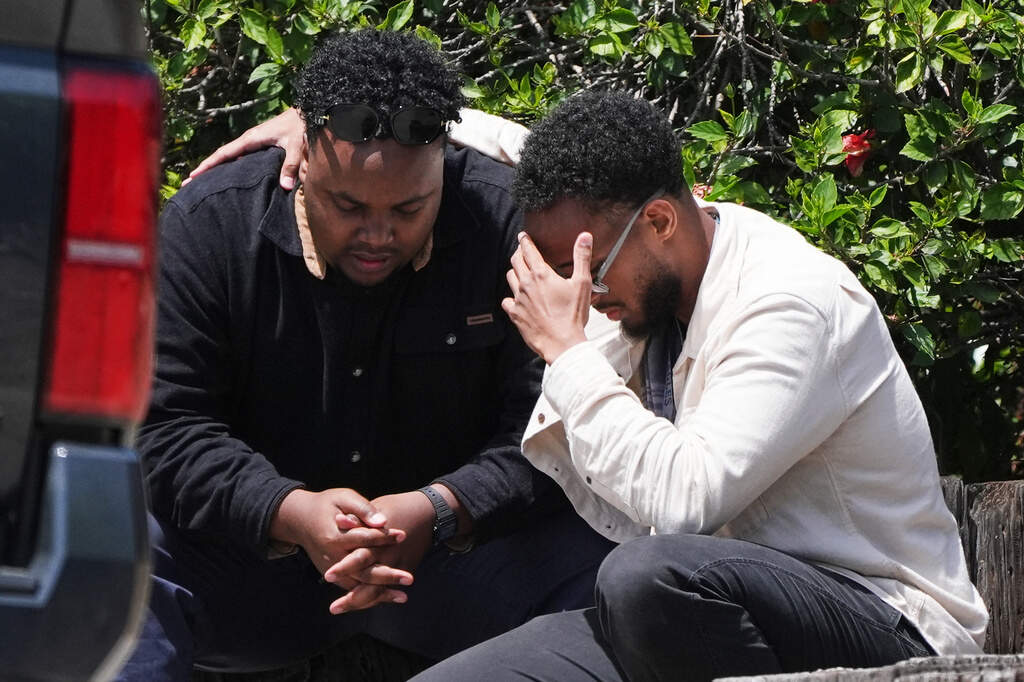 Two men embrace at the scene of a shooting outside the Islamic Center of San Diego Monday, May 18, 2026. (Gregory Bull/AP)
