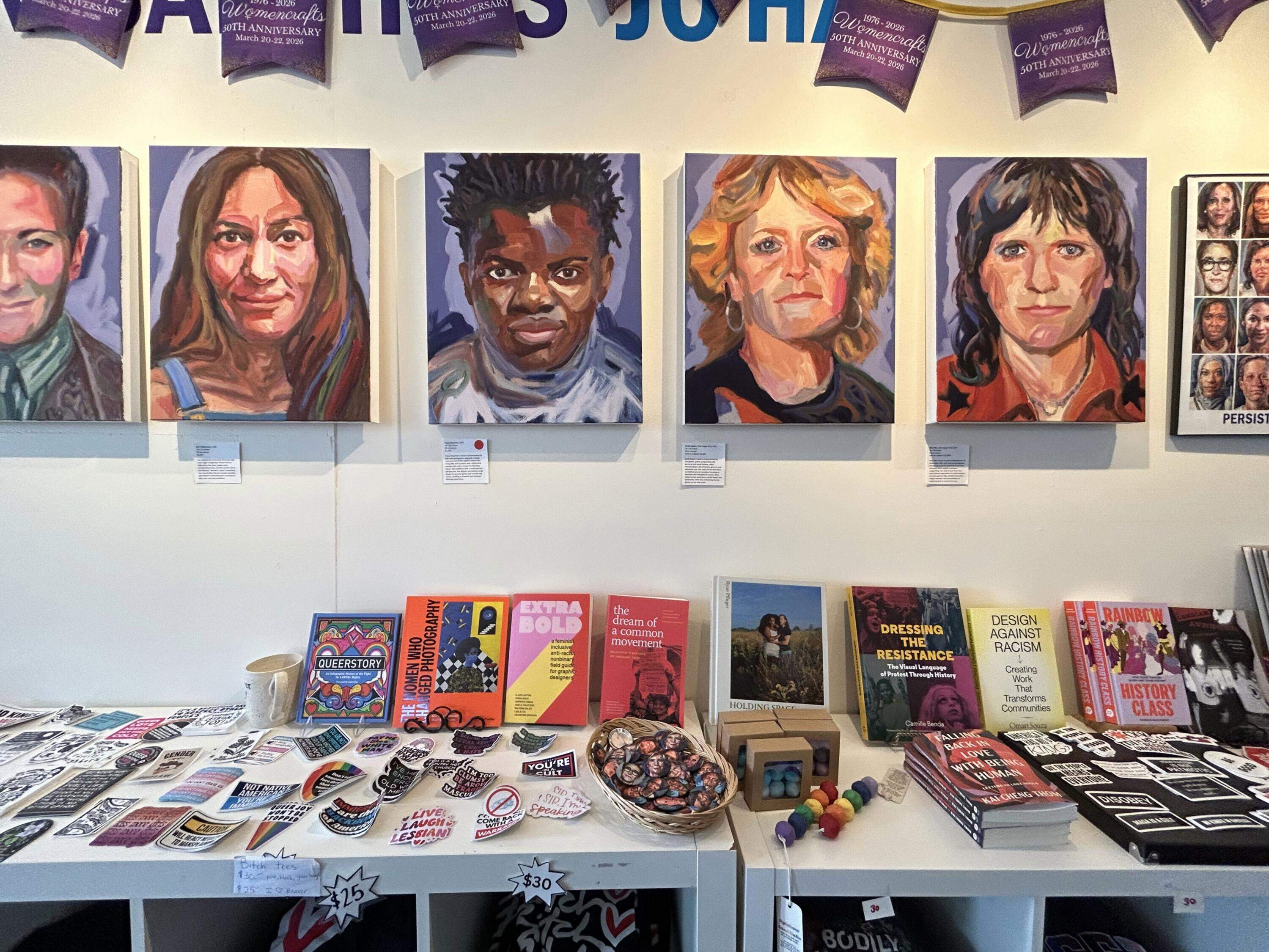 Portraits of activists hang on the wall of Womencrafts. (Amanda Beland/WBUR)