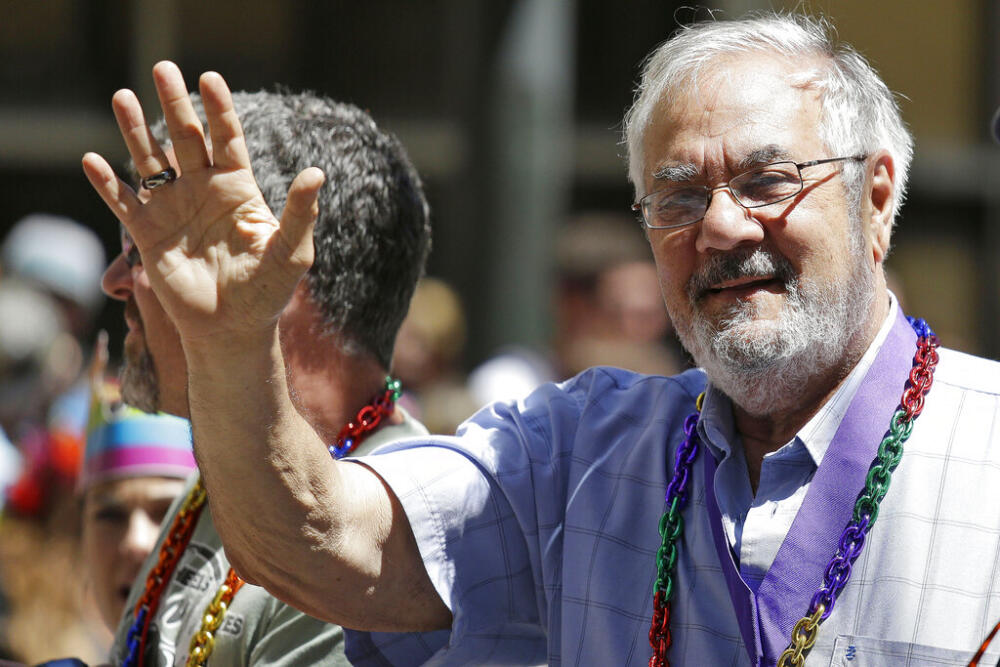 Former Massachusetts congressman Barney Frank, right, waves while riding with his husband James Ready, left, during the San Francisco Gay Pride parade, June 29, 2014. (Eric Risberg/AP, File)