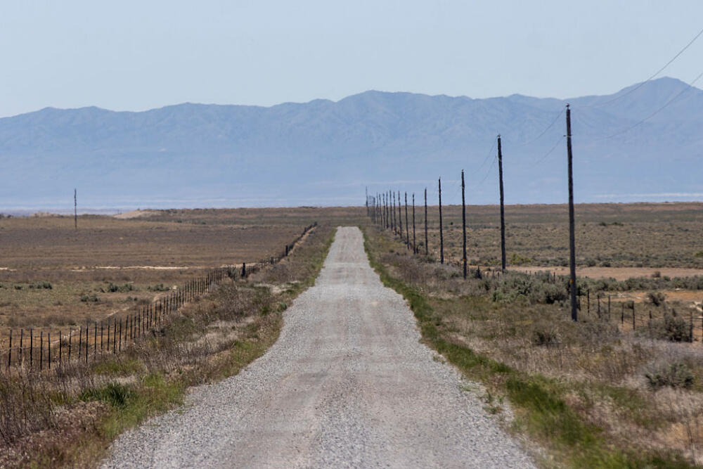 A gravel road stretches through the area where the Stratos Project, a proposed data center, will be built in Box Elder County on May 15, 2026 near Snowville, Utah. The planned construction spans about 40,000 acres and could use up to 9 gigawatts of power. (Photo by Natalie Behring/Getty Images)