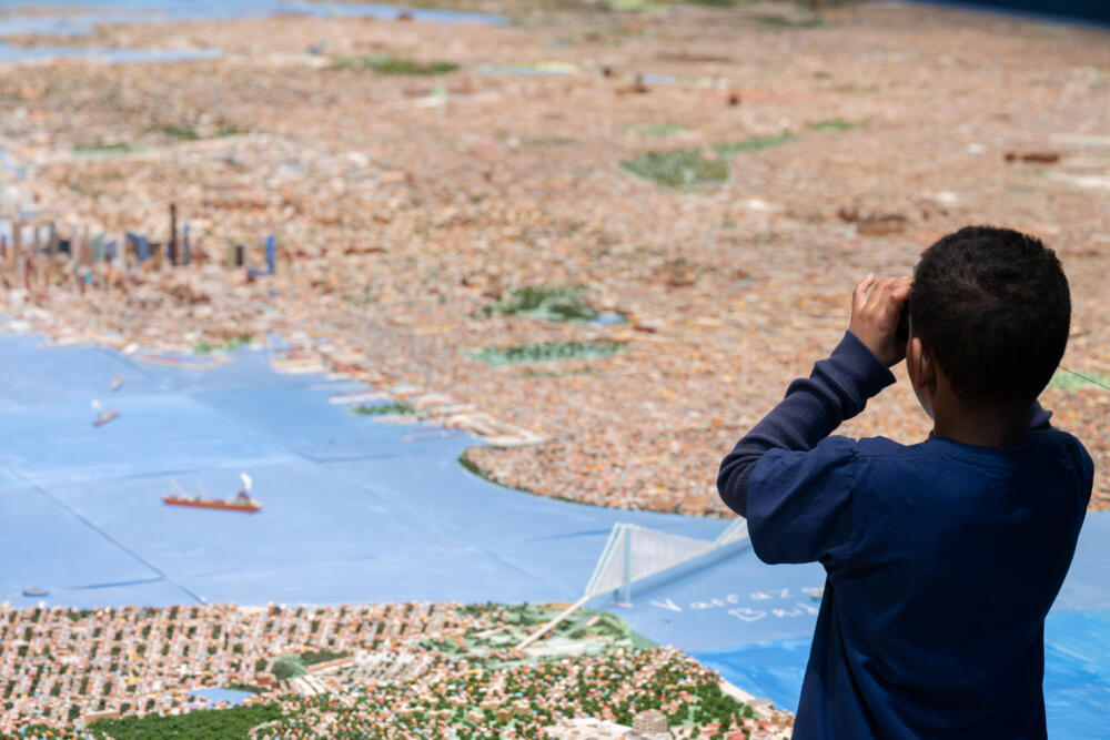 Child takes in the Verrazzano–Narrows Bridge as depicted in "He Built This City." (Filip Wolak/Museum of the City of New York)
