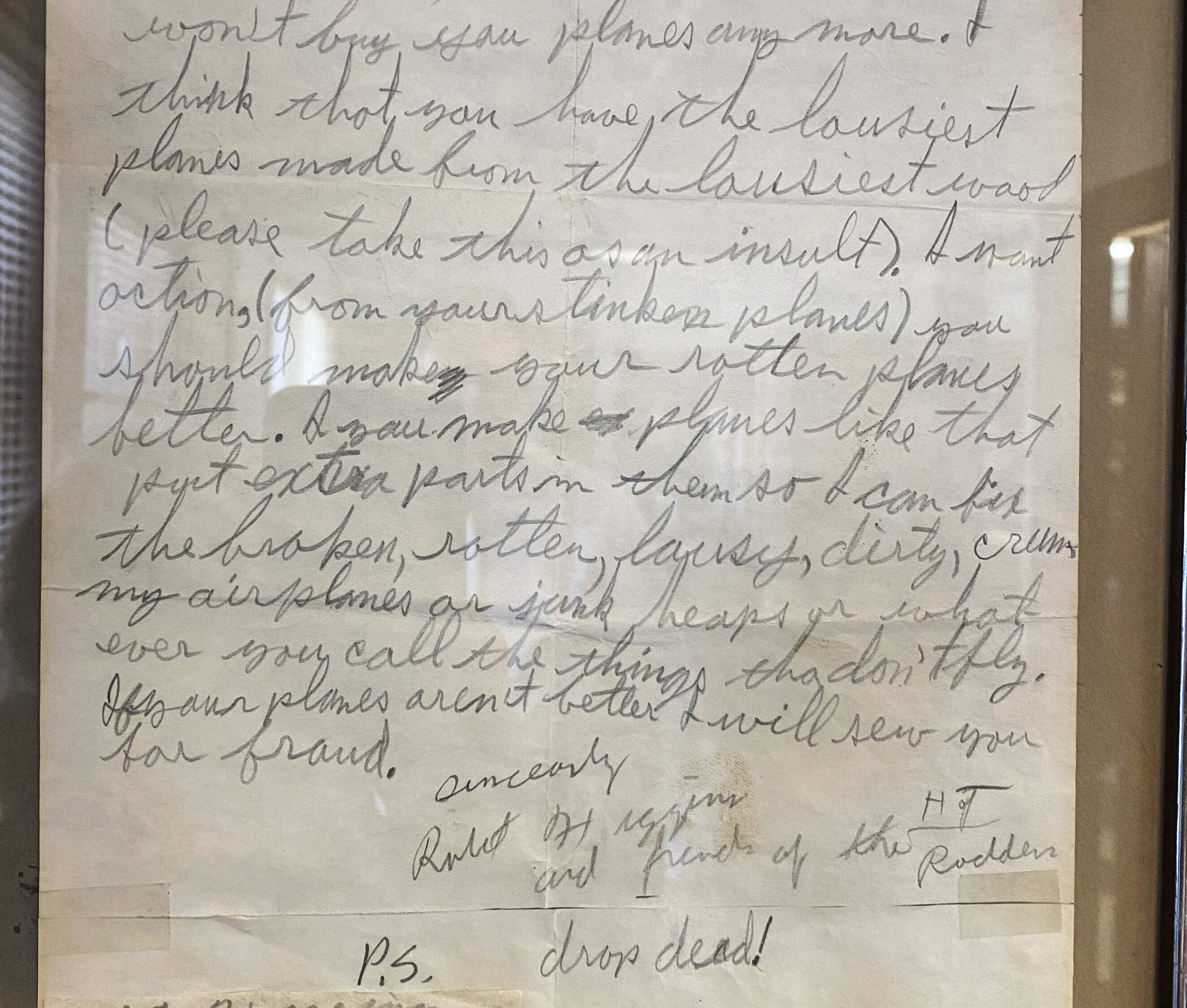 A child's letter of complaint is framed in the Guillow's lobby: "I think that you have the lousiest planes made from the lousiest wood (please take this as an insult). I want actions (from your stinker planes). You should make your rotten planes better. If you make planes like that put extra parts in them so I can fix the broken, rotten, lousy, dirty, crummy airplanes or junk heaps or whatever you call the things that don't fly. If your planes aren't better I will sew you for fraud. P.S. drop dead! (Sharon Brody/WBUR)