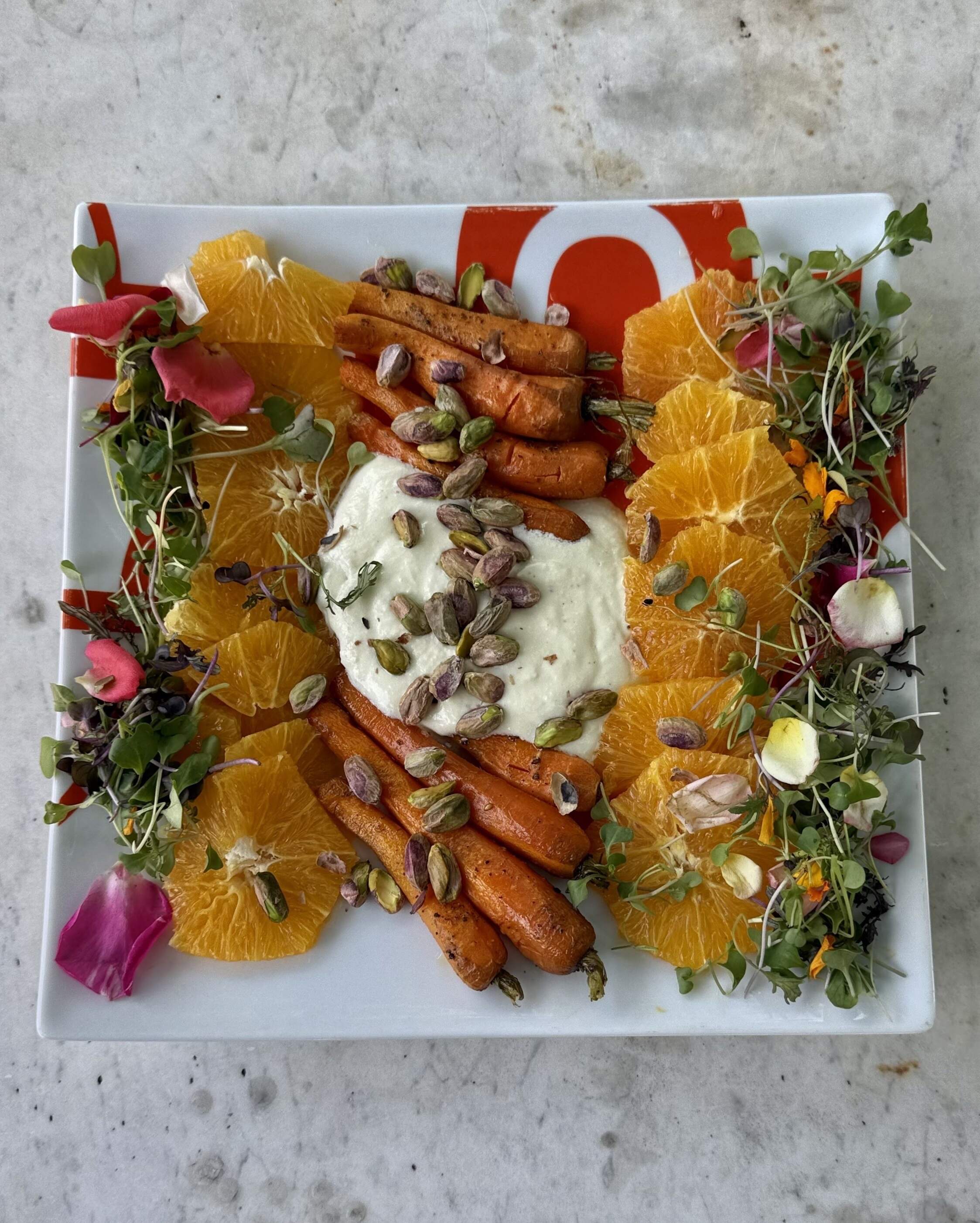 Roasted carrot salad with oranges, pistachios and whipped feta. (Kathy Gunst/Here &amp; Now)