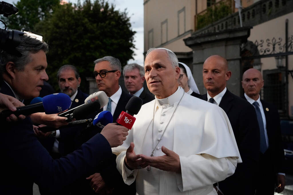 Pope Leo XIV talks to journalists as he leaves his residence in Castel Gandolfo, on the outskirts of Rome, to return to the Vatican, Tuesday, May 26, 2026. (AP Photo/Gregorio Borgia)