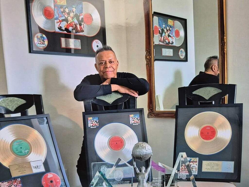 Tony Rose sits surrounded by gold and platinum records and awards he earned throughout his career. (Courtesy Yvonne Rose)