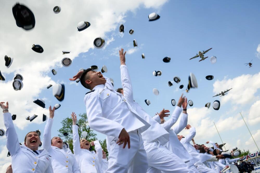 It was all smiles and jubilation Wednesday as cadets celebrate during commencement at the United States Coast Guard Academy in New London. As cadets throw their hats in the air, military planes are flying over them. (Mark Mirko/Connecticut Public)