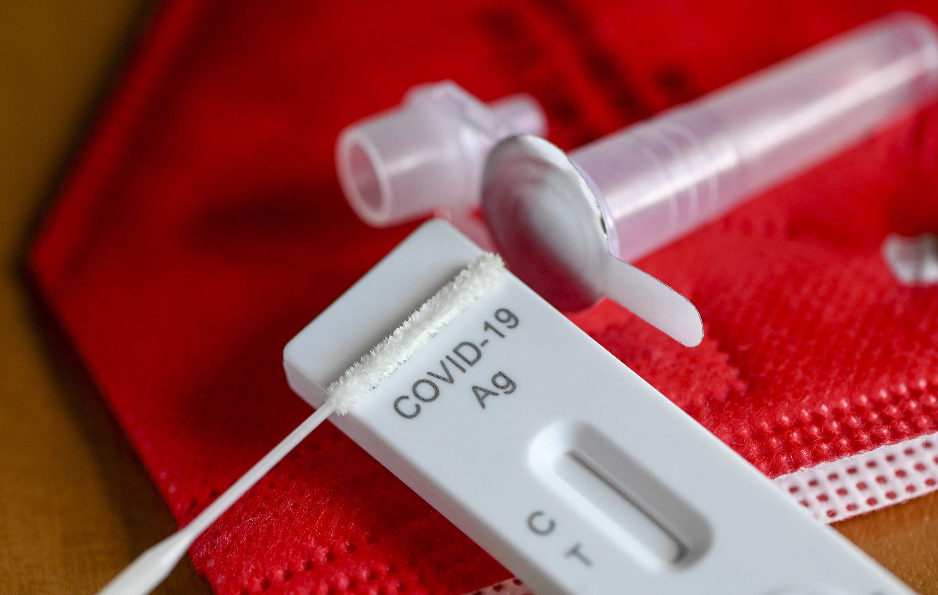 An antigen test to detect COVID-19 for self-testing is on a red mask. (Jens Kalaene/picture alliance via Getty Images)