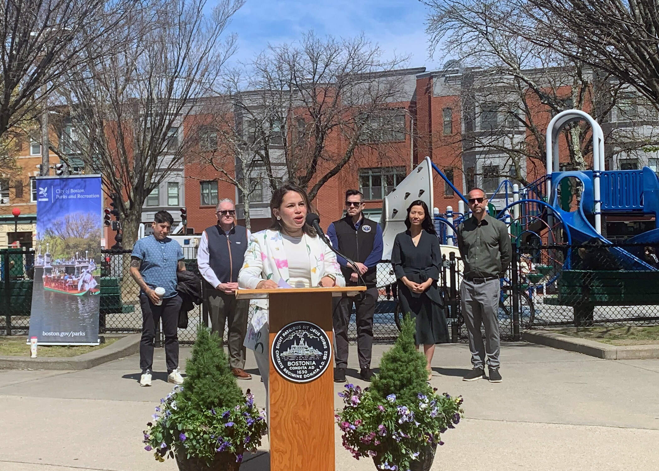 Diana Fernandez Bibeau speaks to an audience at Mozart Park on her new role as the city's new commissioner of parks and recreations. (Kevin Vu/WBUR)
