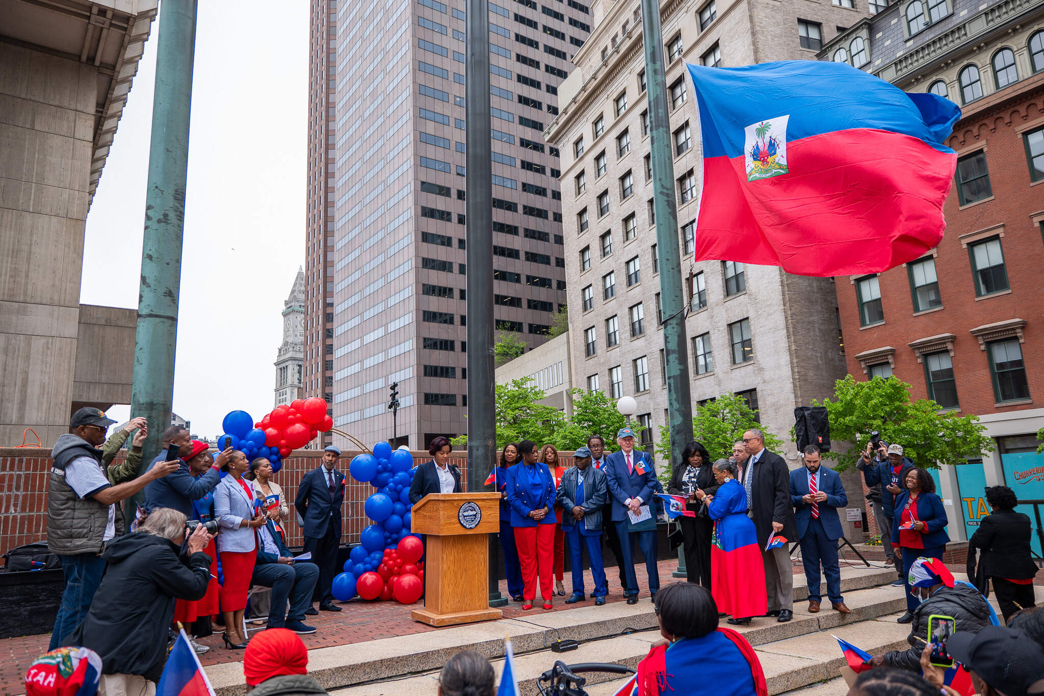 Politicians and local Haitian leaders participate in the raising of Haiti's flag at a recent city hall ceremony. (Courtesy Estailove ST VAL)