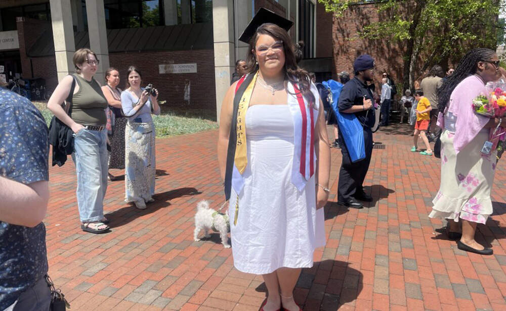 Hampshire College graduate Annez Smith poses after ringing the bell attached to the Harold F. Johnson Library Center. It’s a tradition at the college, where graduating students get to ring the bell after professors sign off on students' final projects. (Nirvani Williams/NEPM)