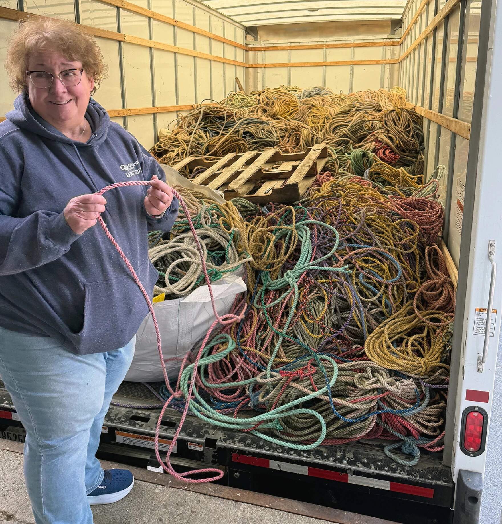 Kim Edwards selects a length of pink rope fresh off the truck from Maine. (Amy Kolb Noyes/CAI)