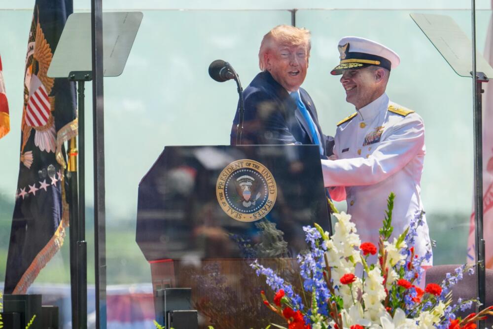President Donald Trump greets Rear Admiral Gregory Rothrock before delivering the commencement address at the U.S. Coast Guard Academy in New London, Connecticut on May 20, 2026. (Mark Mirko/Connecticut Public)