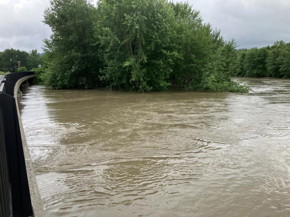 The Lamoille River swells almost to the top of the Wrong Way Bridge in Cambridge, Vermont, during a storm system that caused widespread flooding on July 11, 2024. (Abagael Giles/Vermont Public)