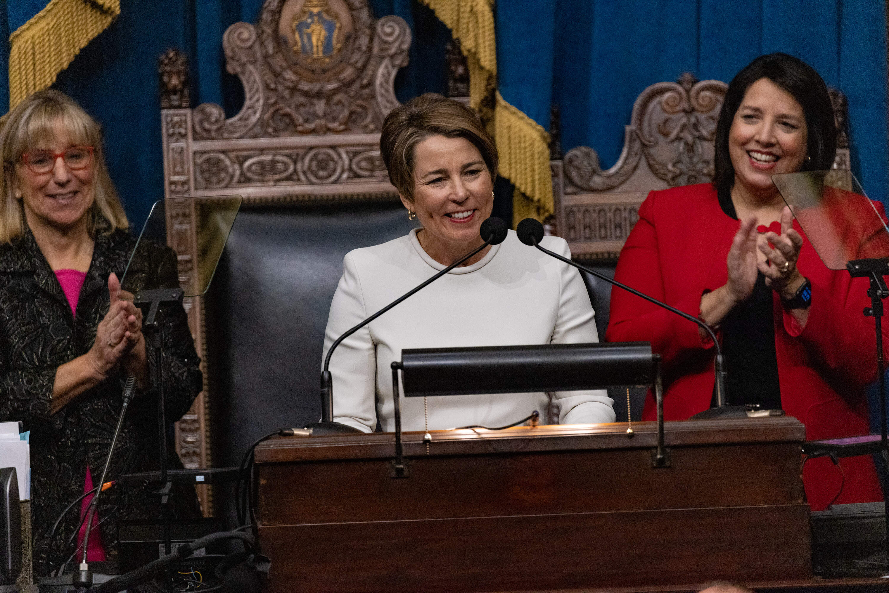 Senate President Karen Spilka and new Lt. Governor Kim Driscoll applaud as the Maura Healey takes the podium to make her first address as Governor of Massachusetts. (Jesse Costa/WBUR)