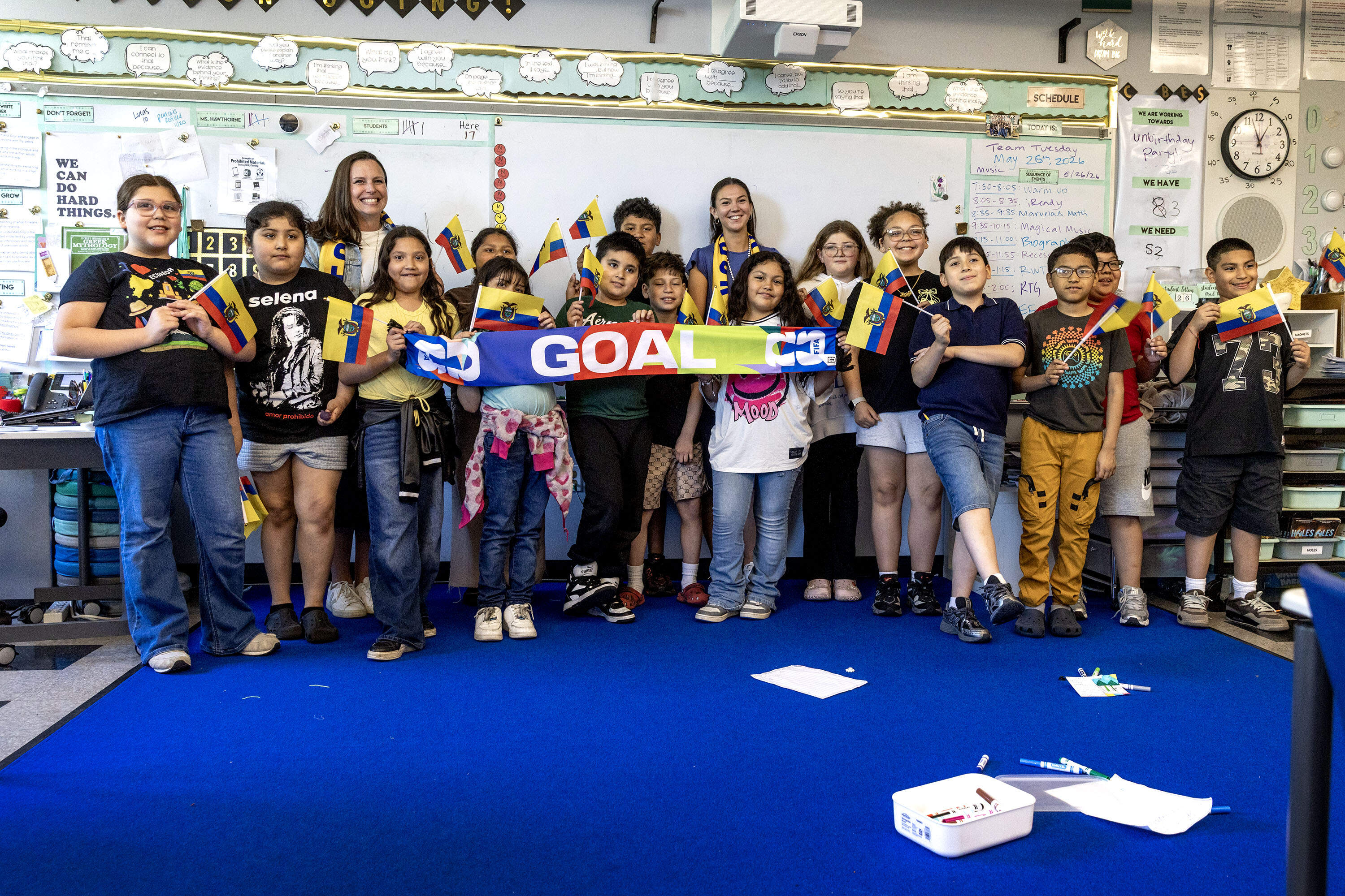 Students at Hooks Elementary School in Chelsea hold the flag of Ecuador and a sign saying "goal". (Robin Lubbock/WBUR)