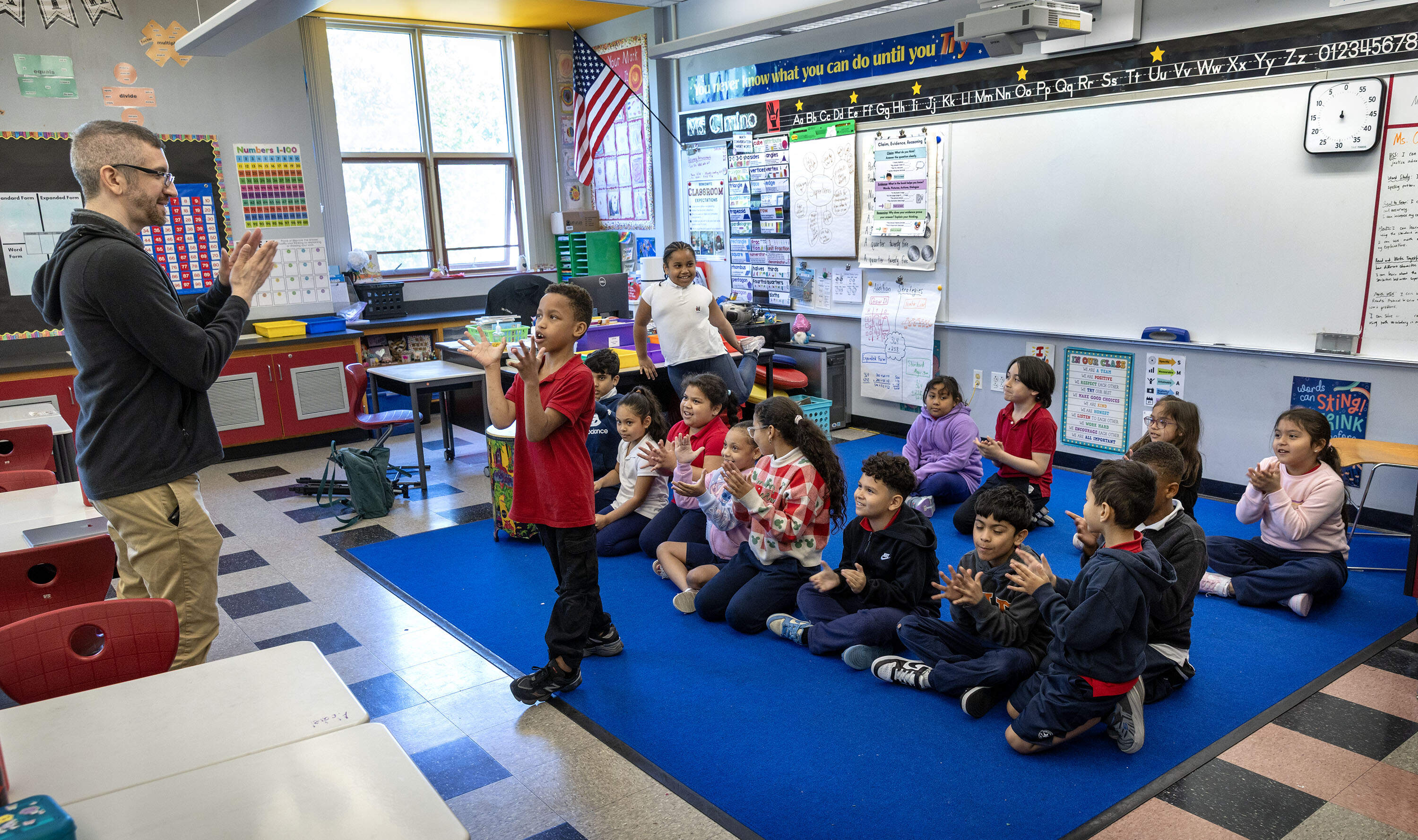 Music teacher Richard Romanoff leads students in a soccer chant at the Berkowitz School in Chelsea. (Robin Lubbock/WBUR)
