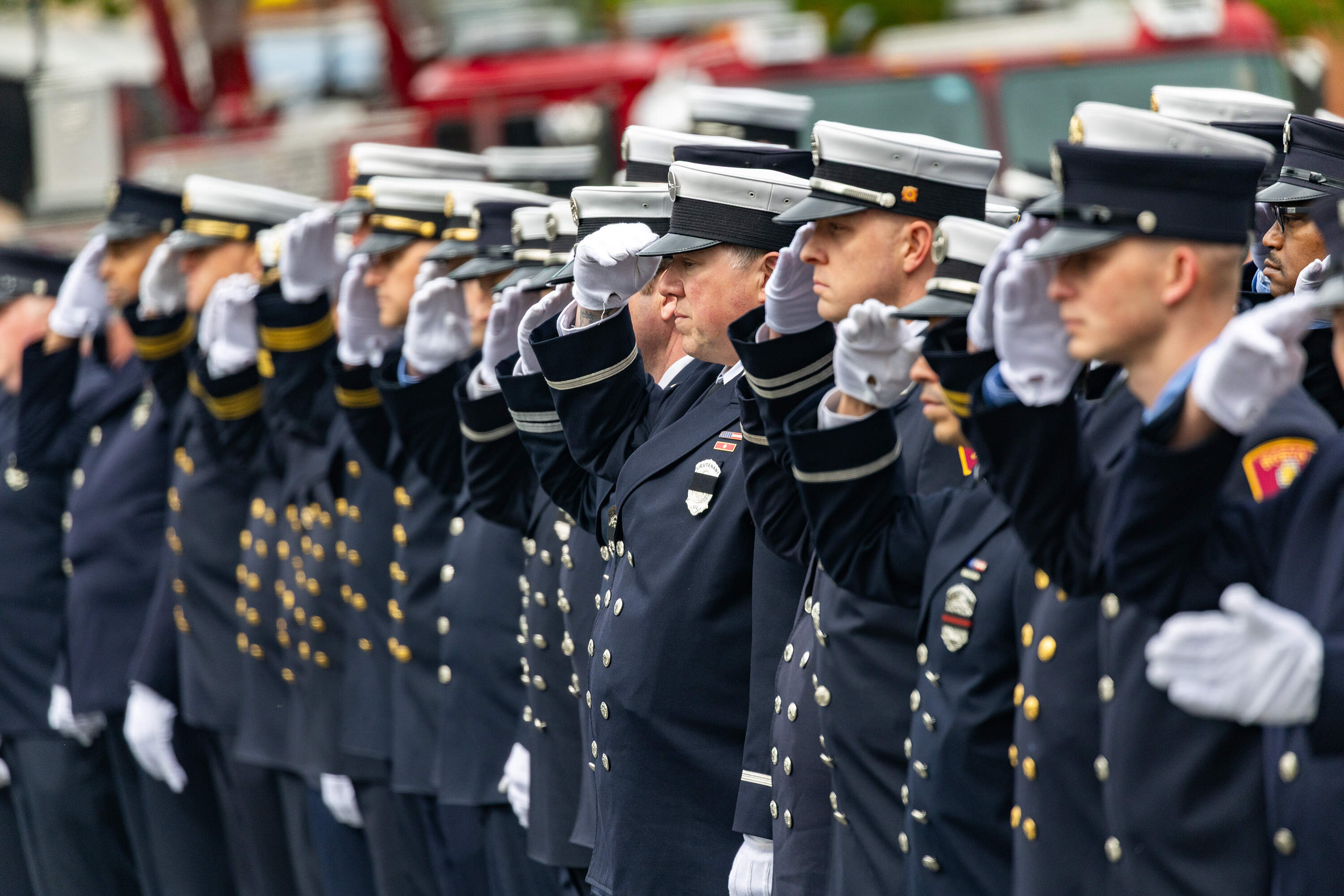 Firefighters stand at attention before the funeral for Robert Kilduff Jr. (Jesse Costa/WBUR)