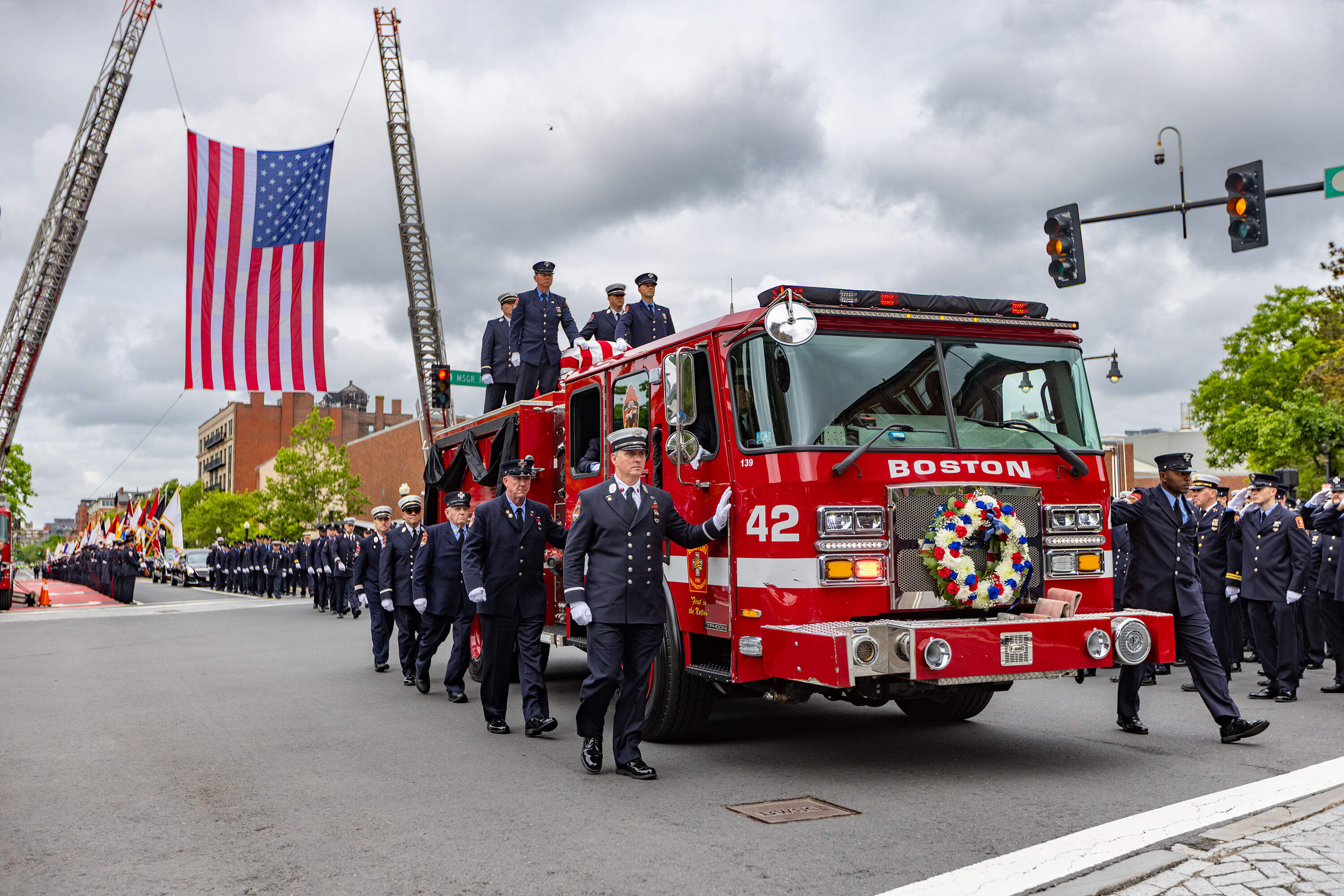 The casket of Robert Kilduff Jr. arrives at the Cathedral of the Holy Cross on Engine 42. (Jesse Costa/WBUR)