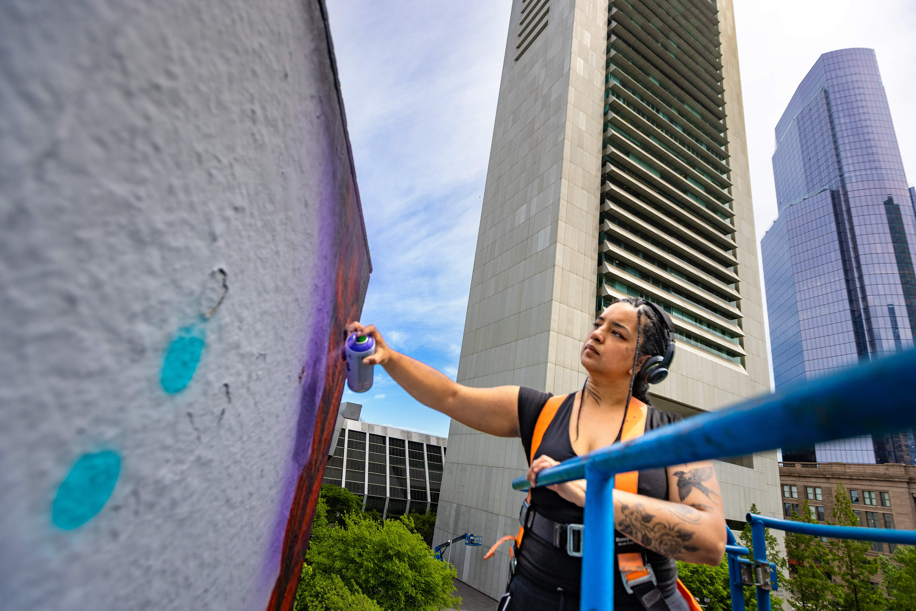 Local artist Rixy puts the finishing touches on her mural “The Midnight Ride” at Dewey Square. (Jesse Costa/WBUR)