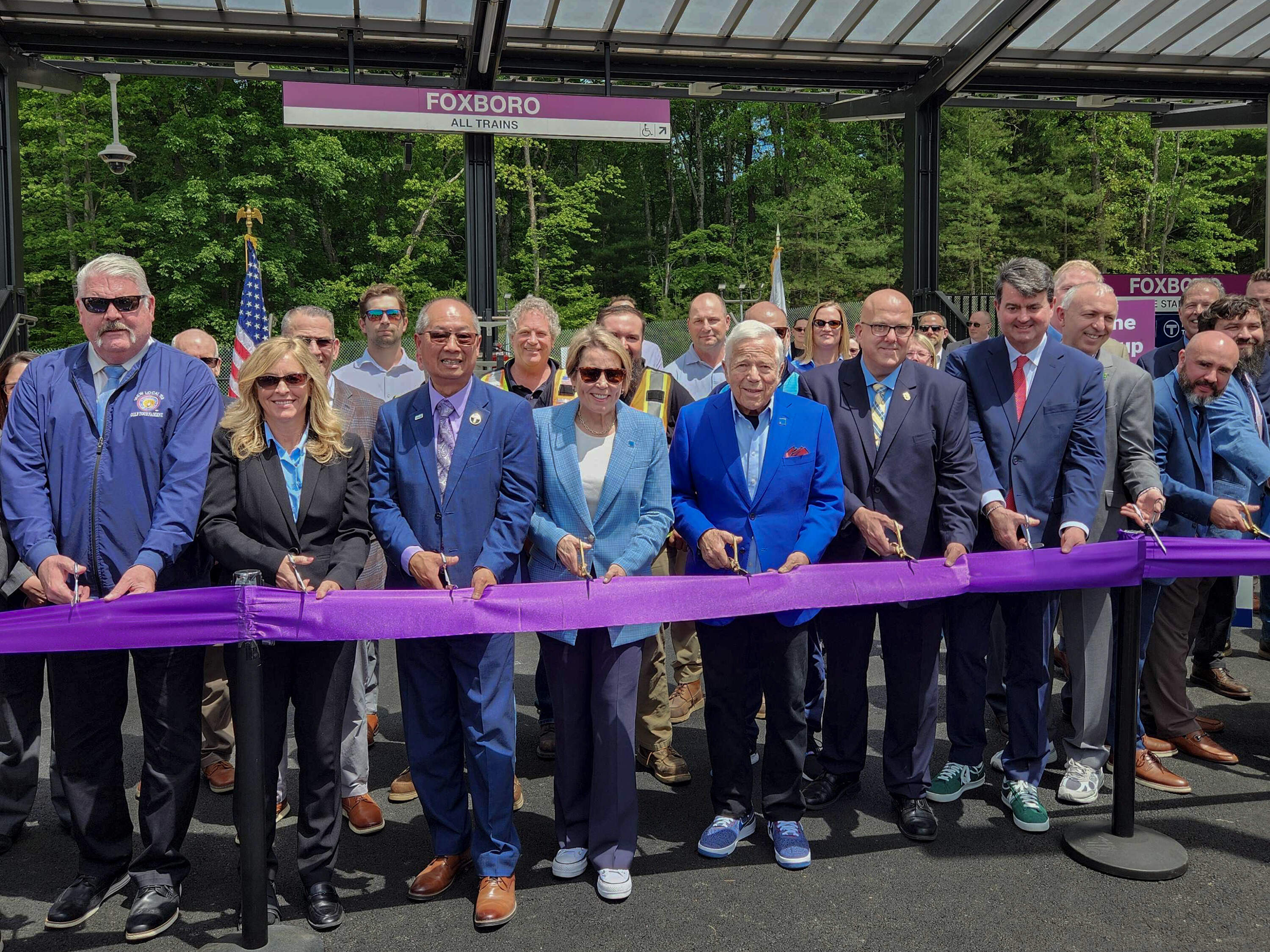 MBTA chief Phil Eng, Gov. Maura Healey and Gillette Stadium owner Bob Kraft are among those at ribbon cutting for updated Foxborough train station near Gillette. (Andrea Perdomo-Hernandez/WBUR)