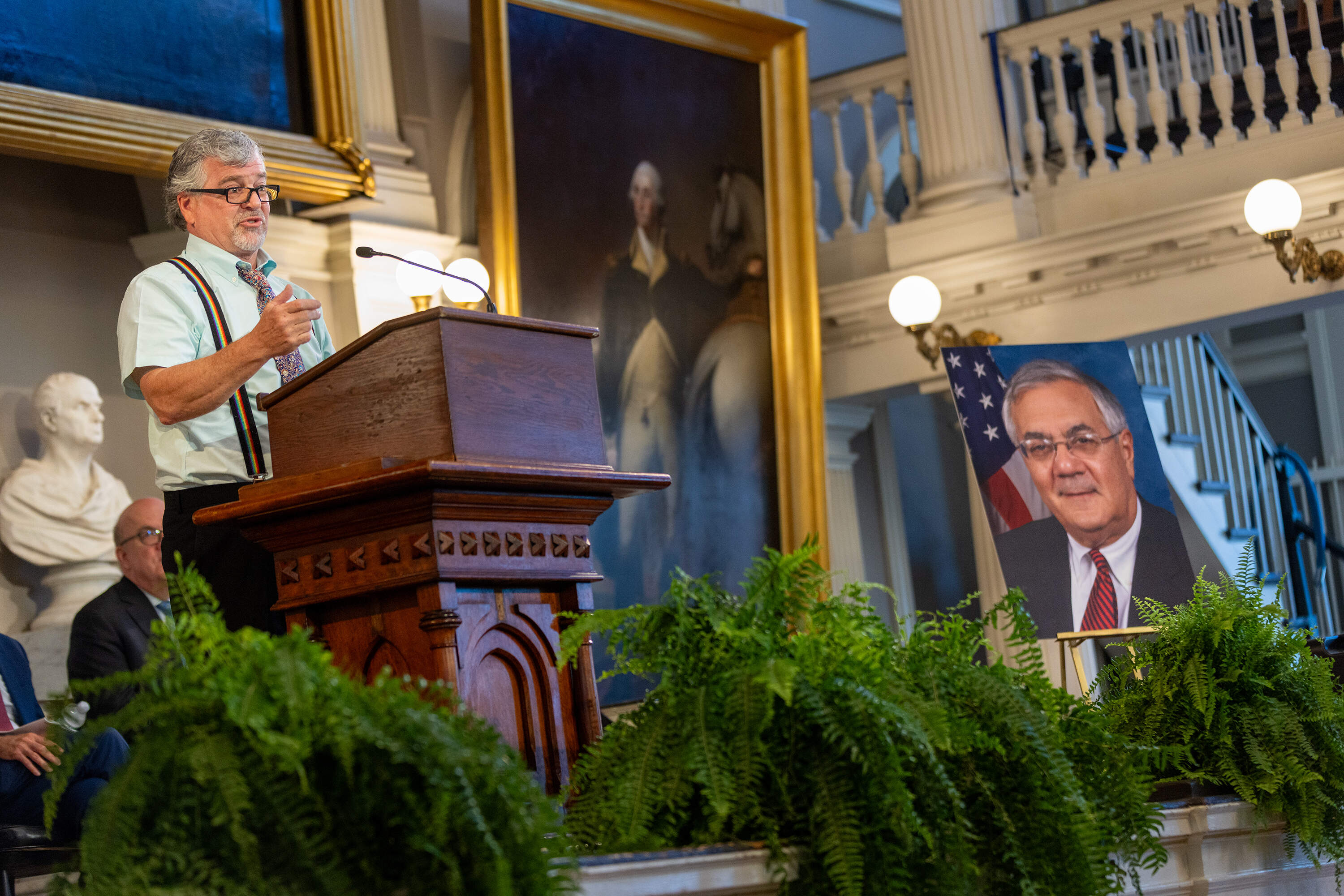 Barney Frank’s widower, Jim Ready, speaks at the podium during a "celebration of life" ceremony for the late congressman in Boston. (Jesse Costa/WBUR)