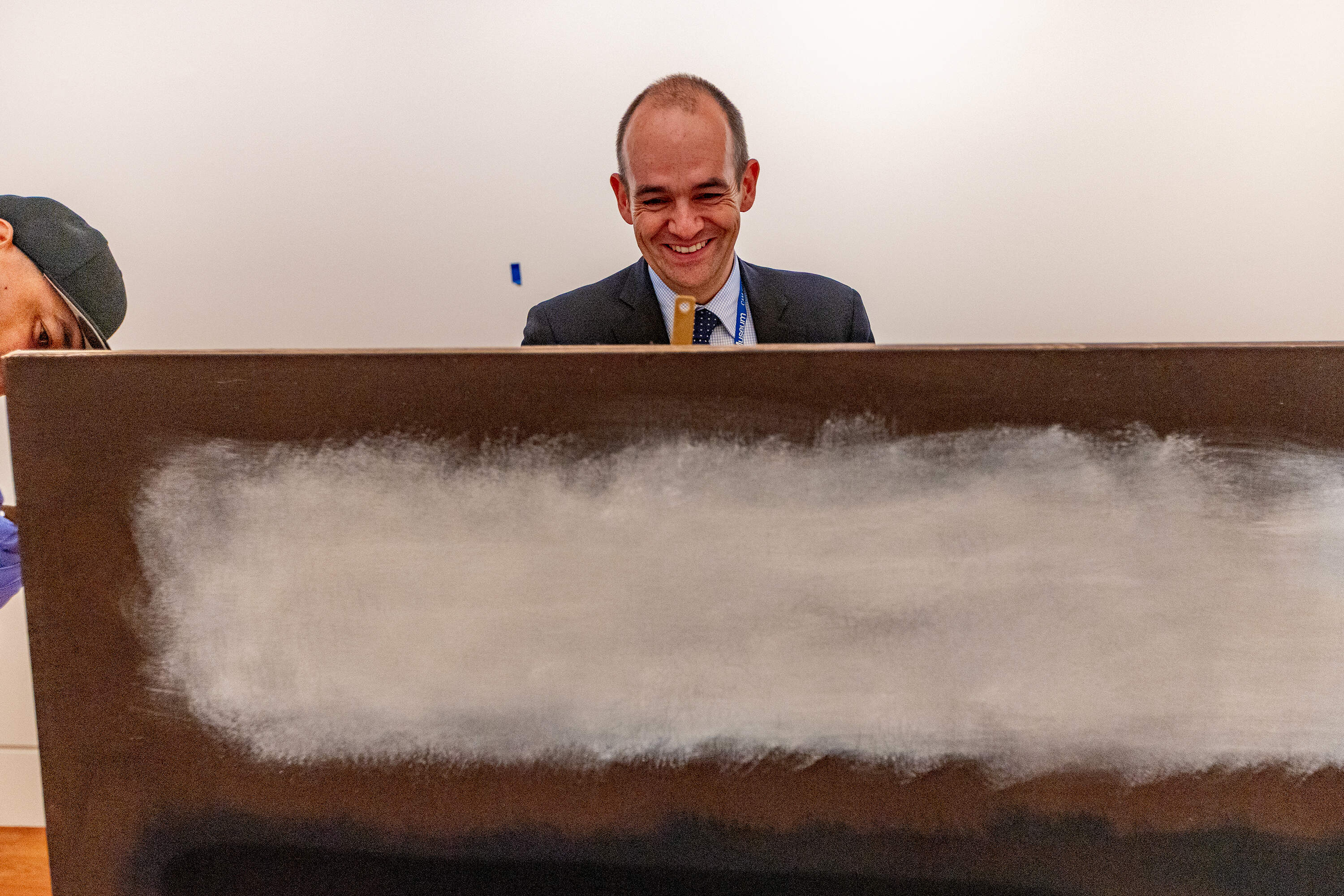 Cape Ann Museum director Oliver Barker is all smiles after the unpacking of the Rothko from the Modern Museum of Art. (Jesse Costa/WBUR)