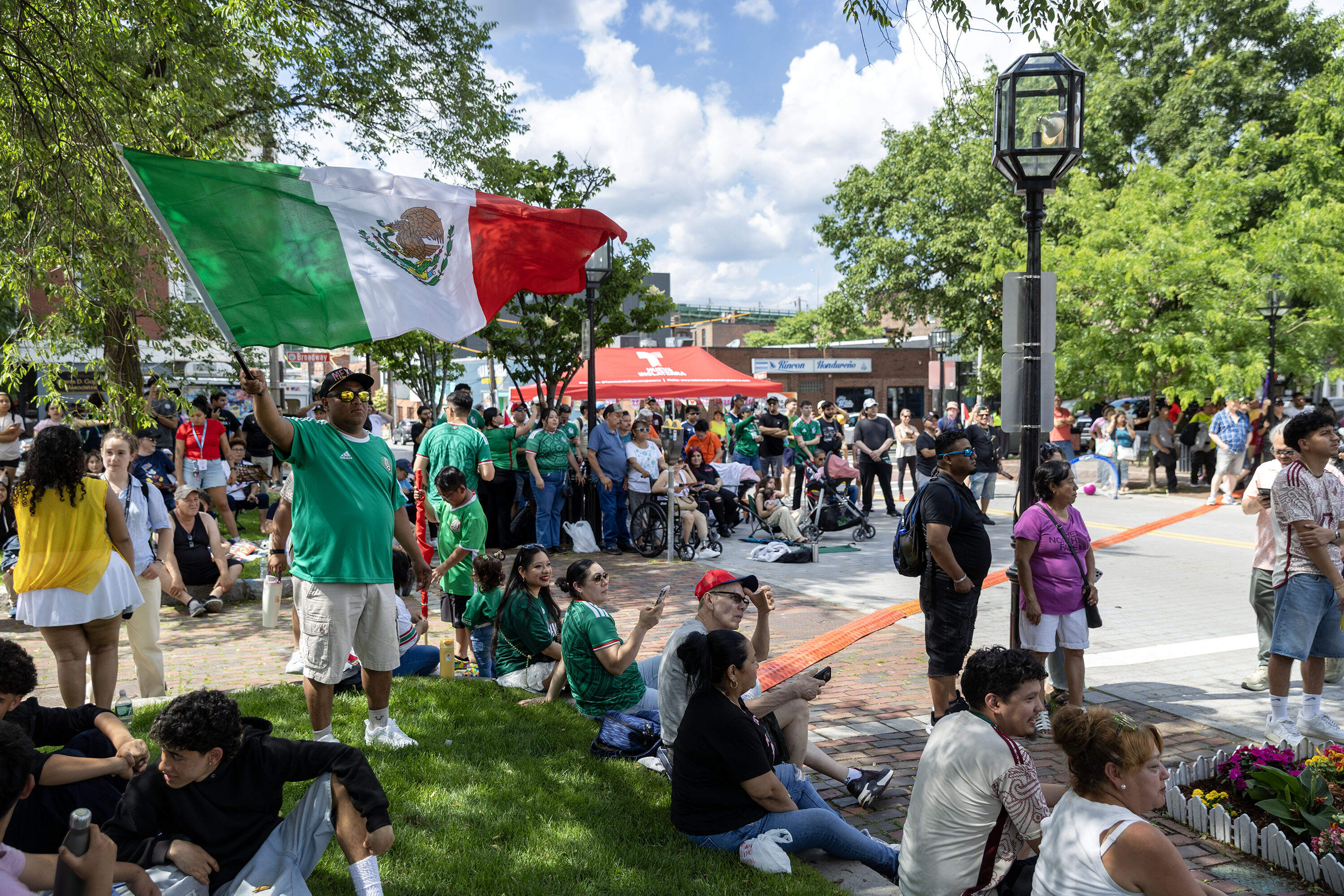 A fan waves the Mexican flag at the "Fiesta Fútbol." (Robin Lubbock/WBUR)