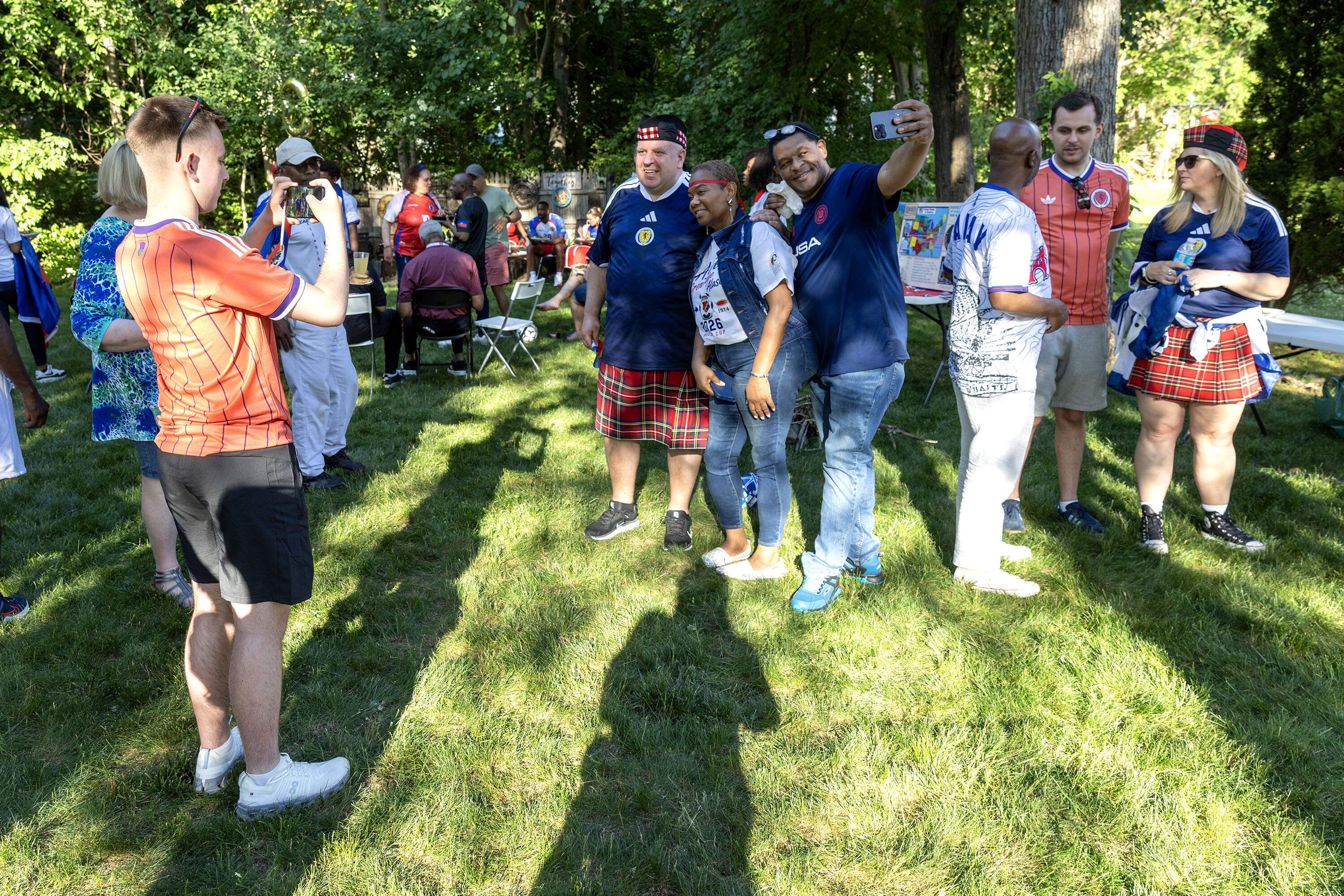 Scottish and Haitian fans pose for a photo at the Lucien's watch party ahead of the match. (Robin Lubbock/WBUR)
