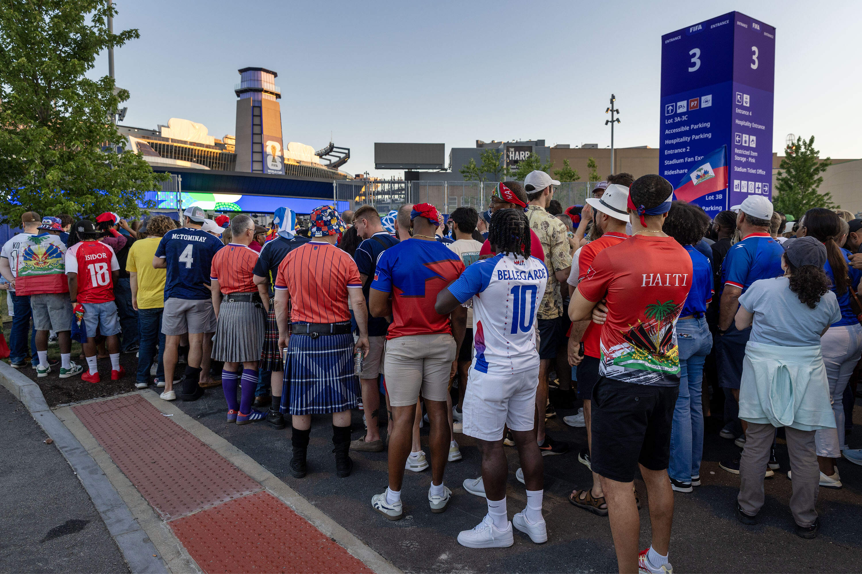 Fans of Scotland and Haiti line up to enter the stadium before the first game of the 2026 Men's Soccer World Cup to be played in Foxborough, Mass. (Robin Lubbock/WBUR)