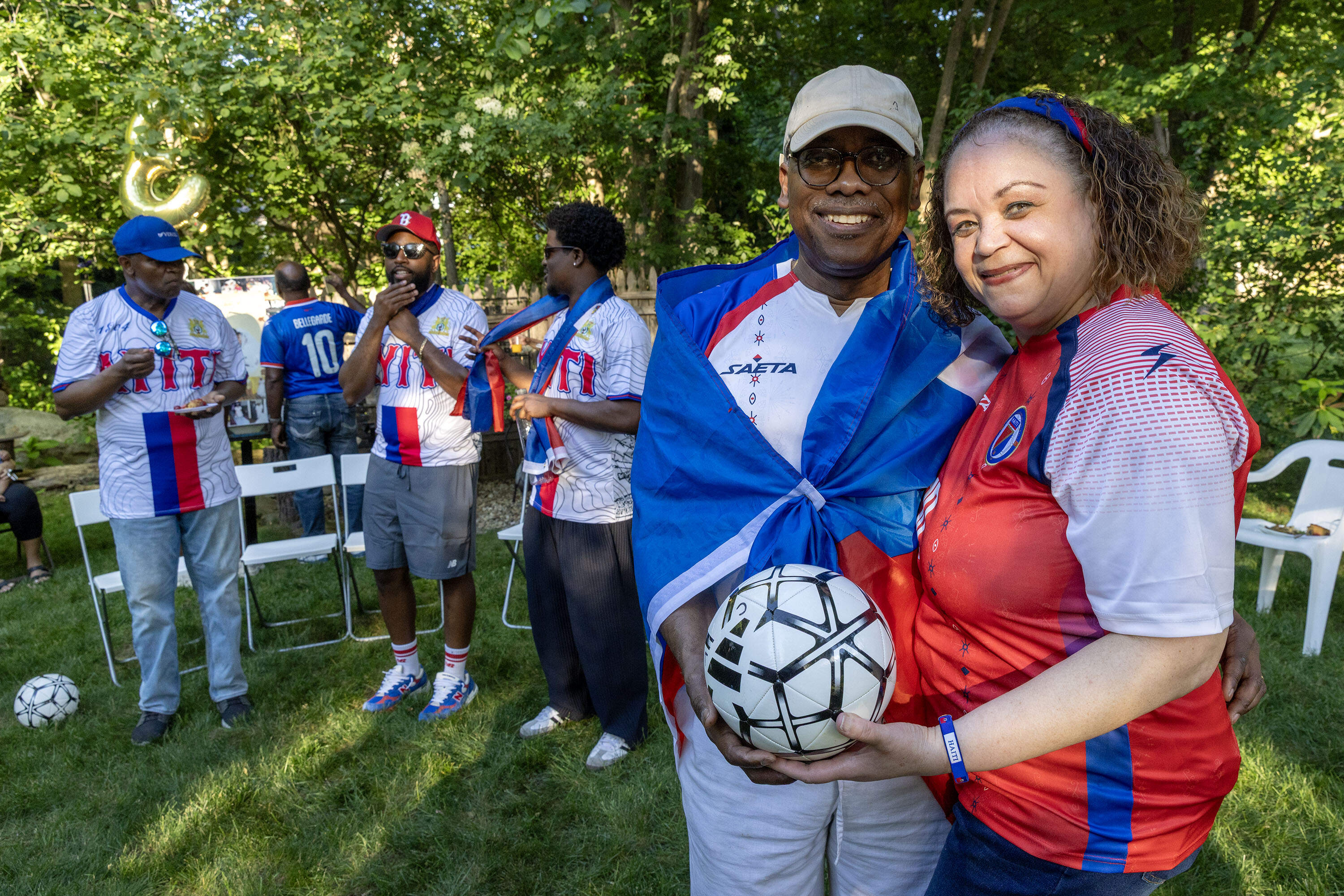 Foxborough cookout hosts post prior to the Haiti-Scotland match, Charlot Lucien and Marie Evangeline Roussel Lucien. (Robin Lubbock/WBUR)