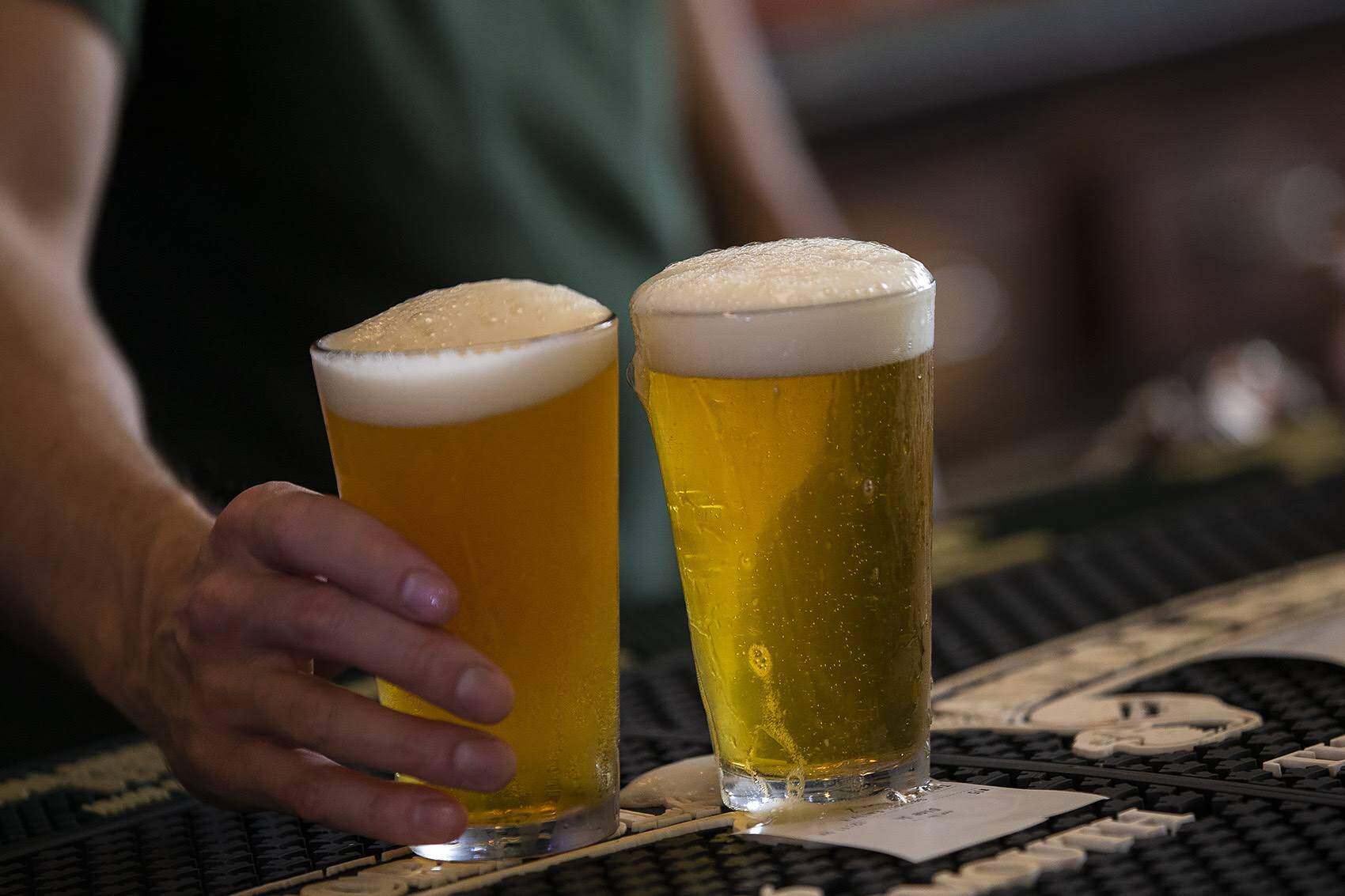 A bartender serving up a couple of pints of beer in Jamaica Plain. (Jesse Costa/WBUR)