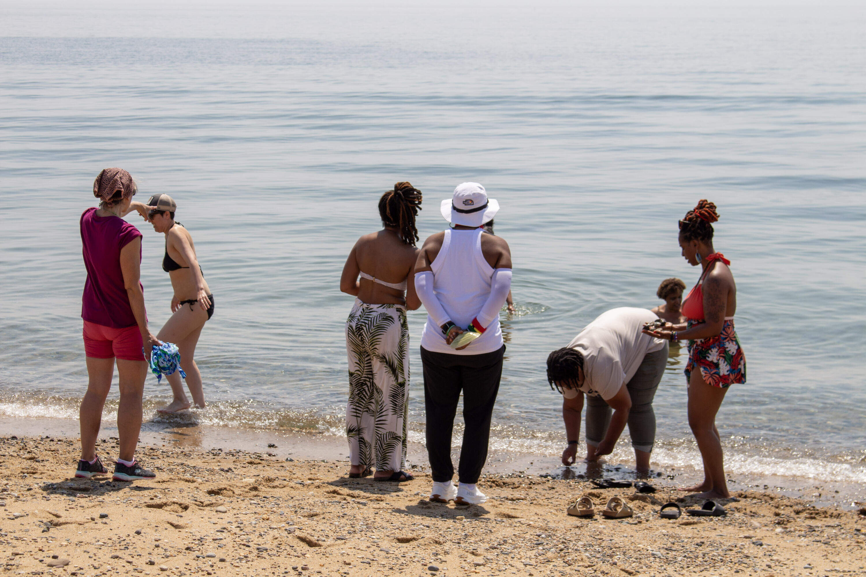 Attendees gather on the beach in Provincetown at the 2025 Womxn of Color Weekend (Courtesy Phree)