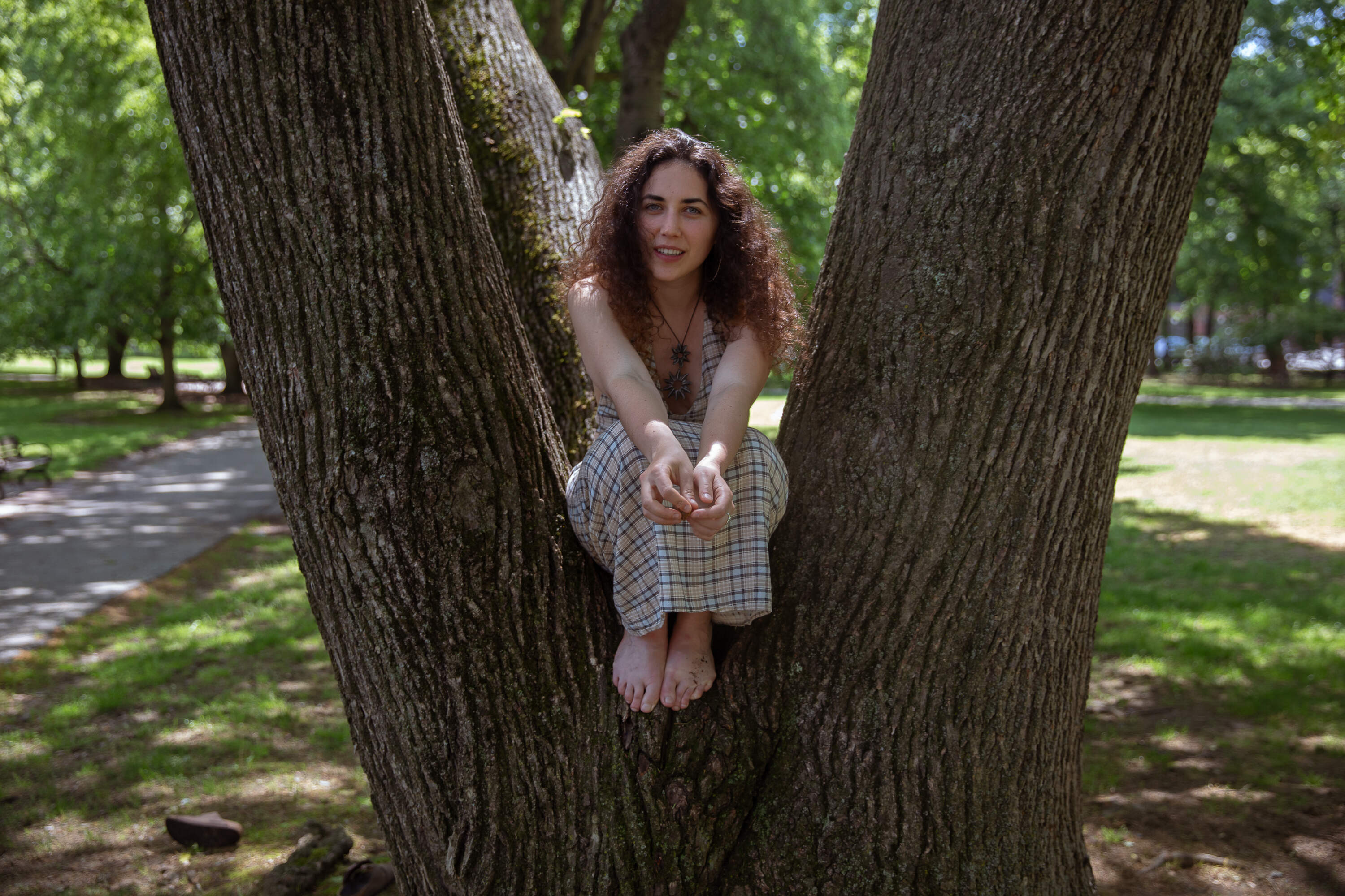 Singer-songwriter Ella Faye poses at Knyvet Square in Brookline. Faye’s entry “Aurora,” an ode to nature, was selected as the 2026 Massachusetts Tiny Desk Favorite. (Artemisia Luk/WBUR)