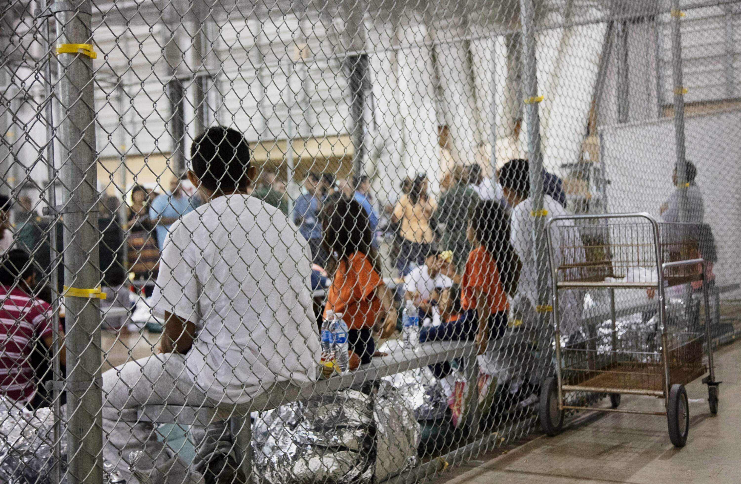 In this photo provided by U.S. Customs and Border Protection, people who've been taken into custody related to cases of illegal entry into the United States, sit in one of the cages at a facility in McAllen, Texas, on June 17, 2018. (U.S. Customs and Border Protection's Rio Grande Valley Sector via AP, File)