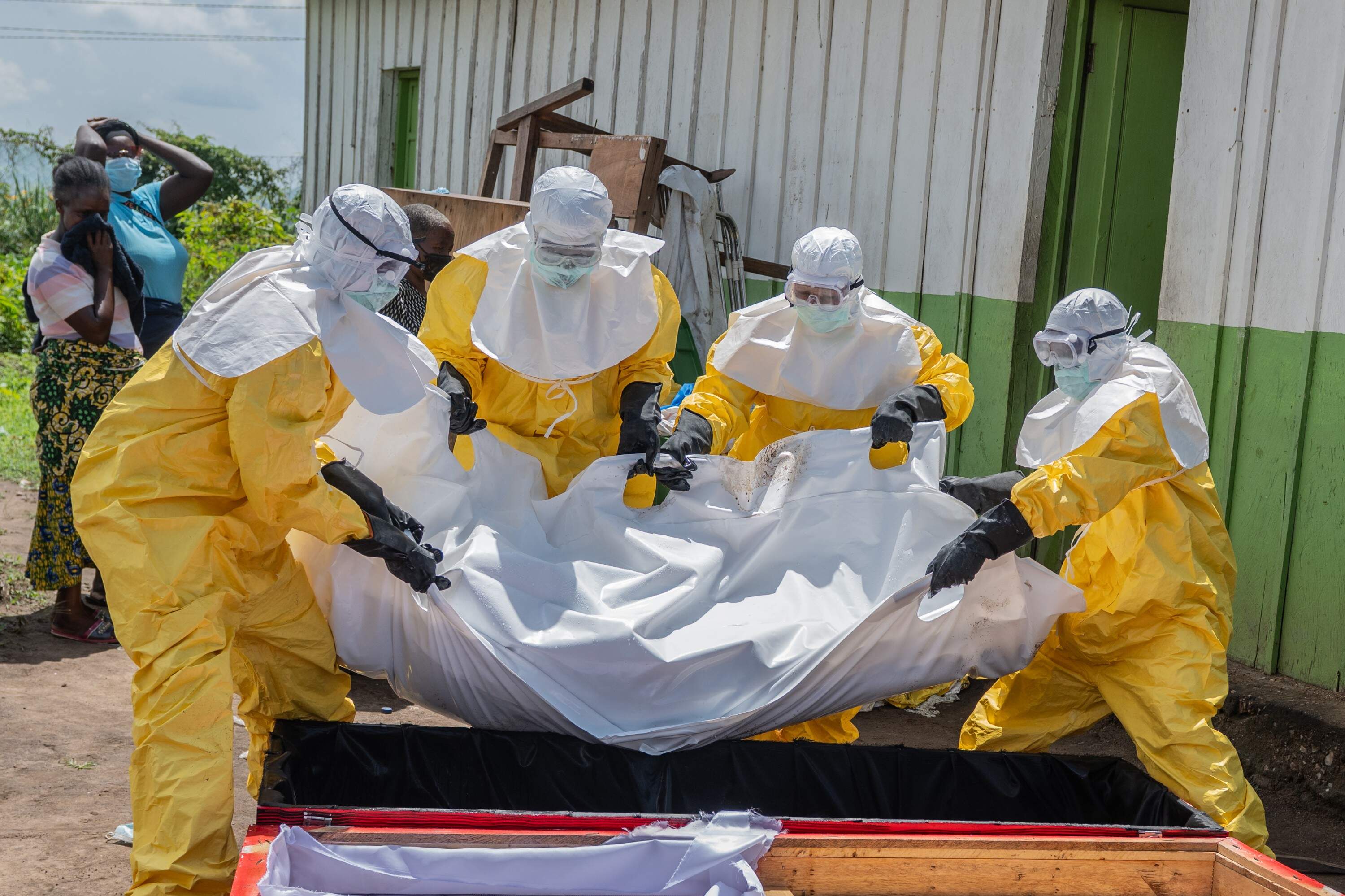 Red Cross workers carry the body of a person who died of Ebola to a coffin at a health center in Rwampara in the Ituri Province of the eastern Democratic Republic of the Congo (DRC) on May 20. (Moses Sawasawa/AP)