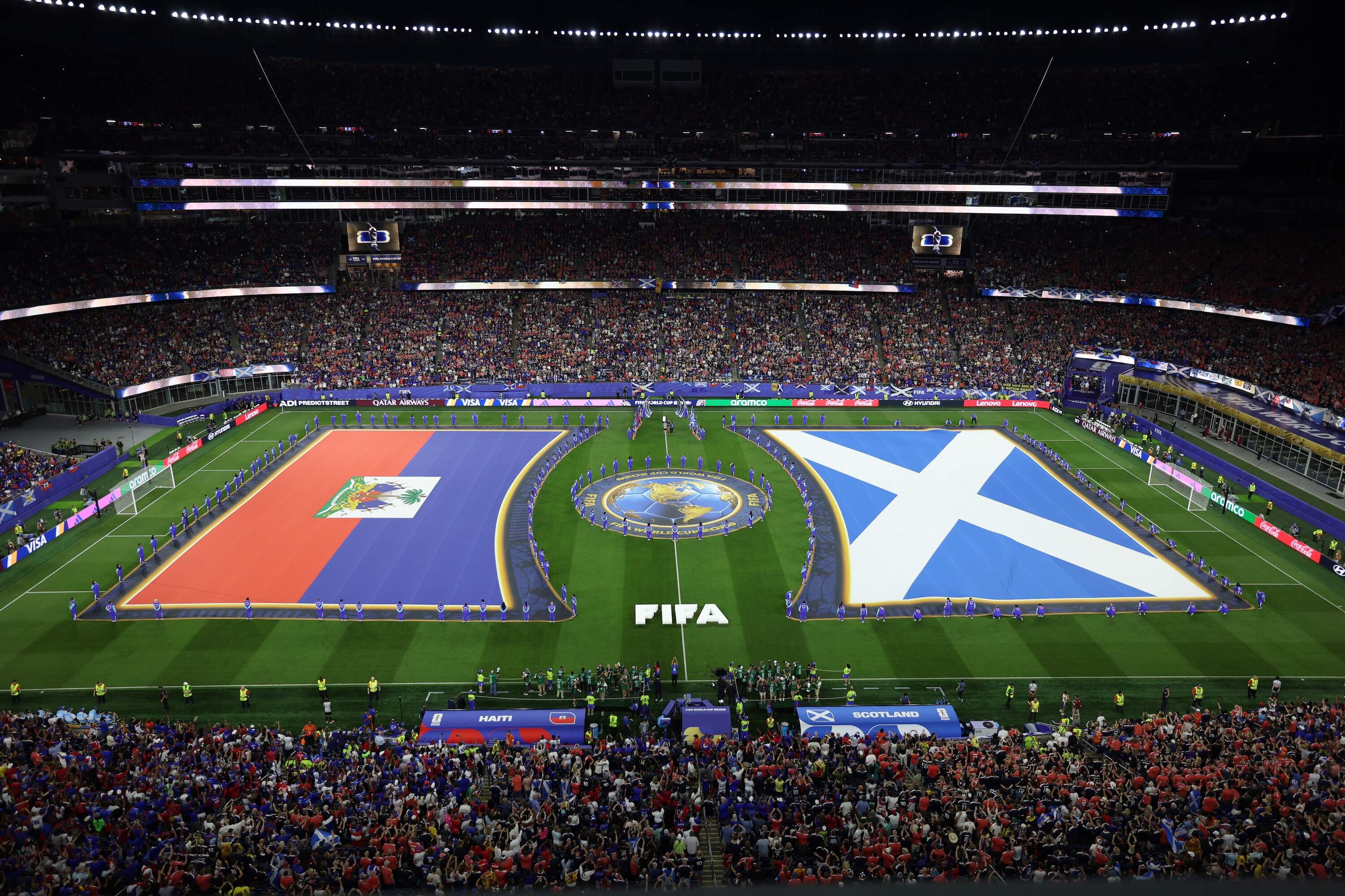 Flags are placed ahead of the World Cup Group C soccer match between Haiti and Scotland in Foxborough. (Mark Stockwell/AP)