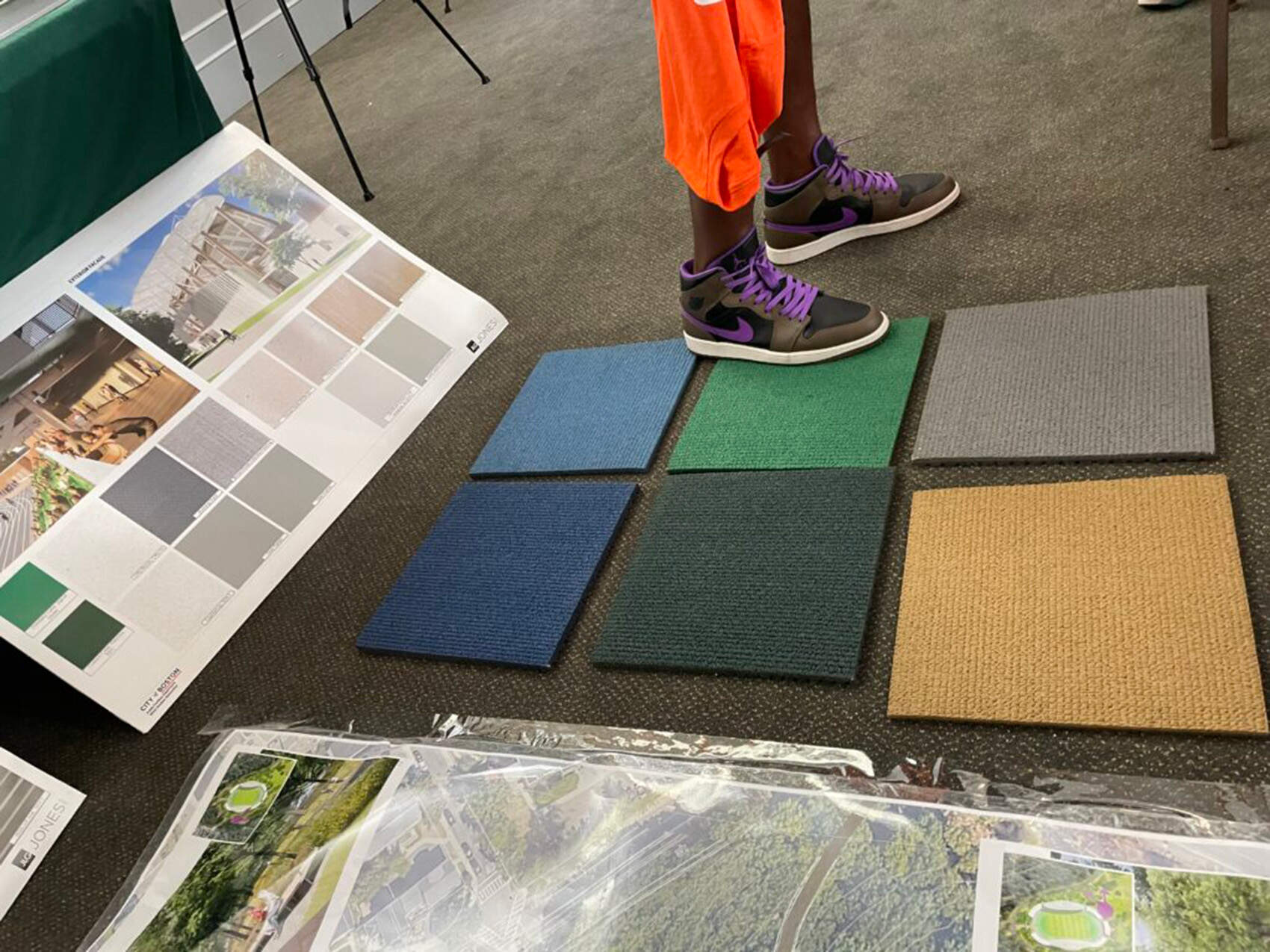 Meeting attendees expressed little interest in weighing in on color swatches for the carpeting and paint that will decorate the inside of the grandstands. (Yawu Miller/Dorchester Reporter)