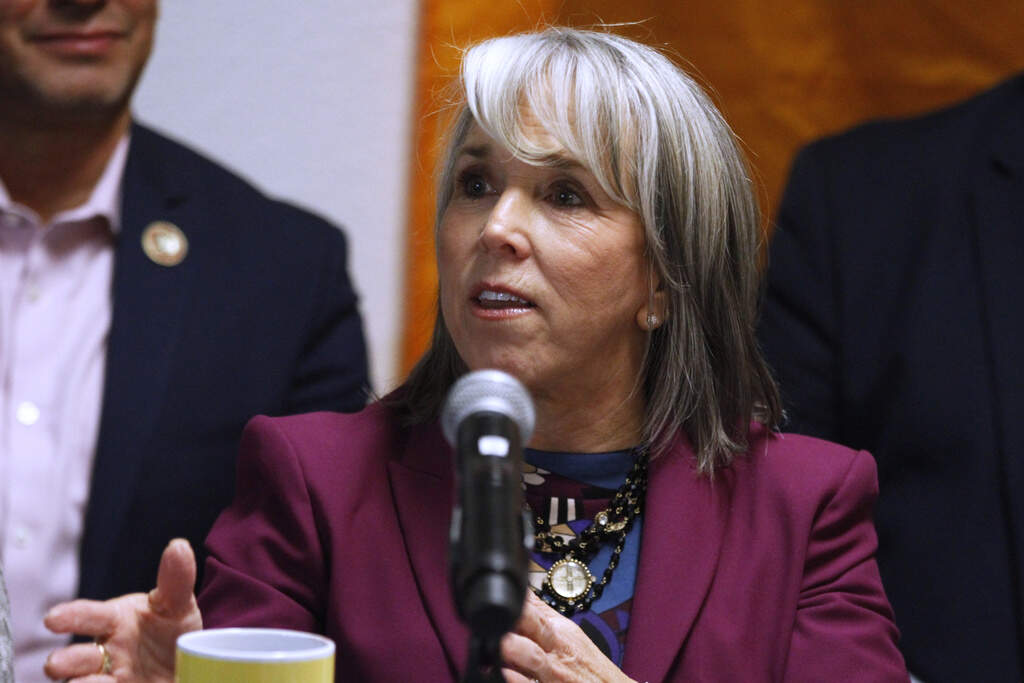 New Mexico Gov. Michelle Lujan Grisham, speaks during a news conference, Tuesday, March 10, 2026, in Santa Fe, N.M., after signing legislation that bars federal immigration agents from election polling sites in New Mexico, in a step being considered by several other Democratic-led states. (AP Photo/Morgan Lee)