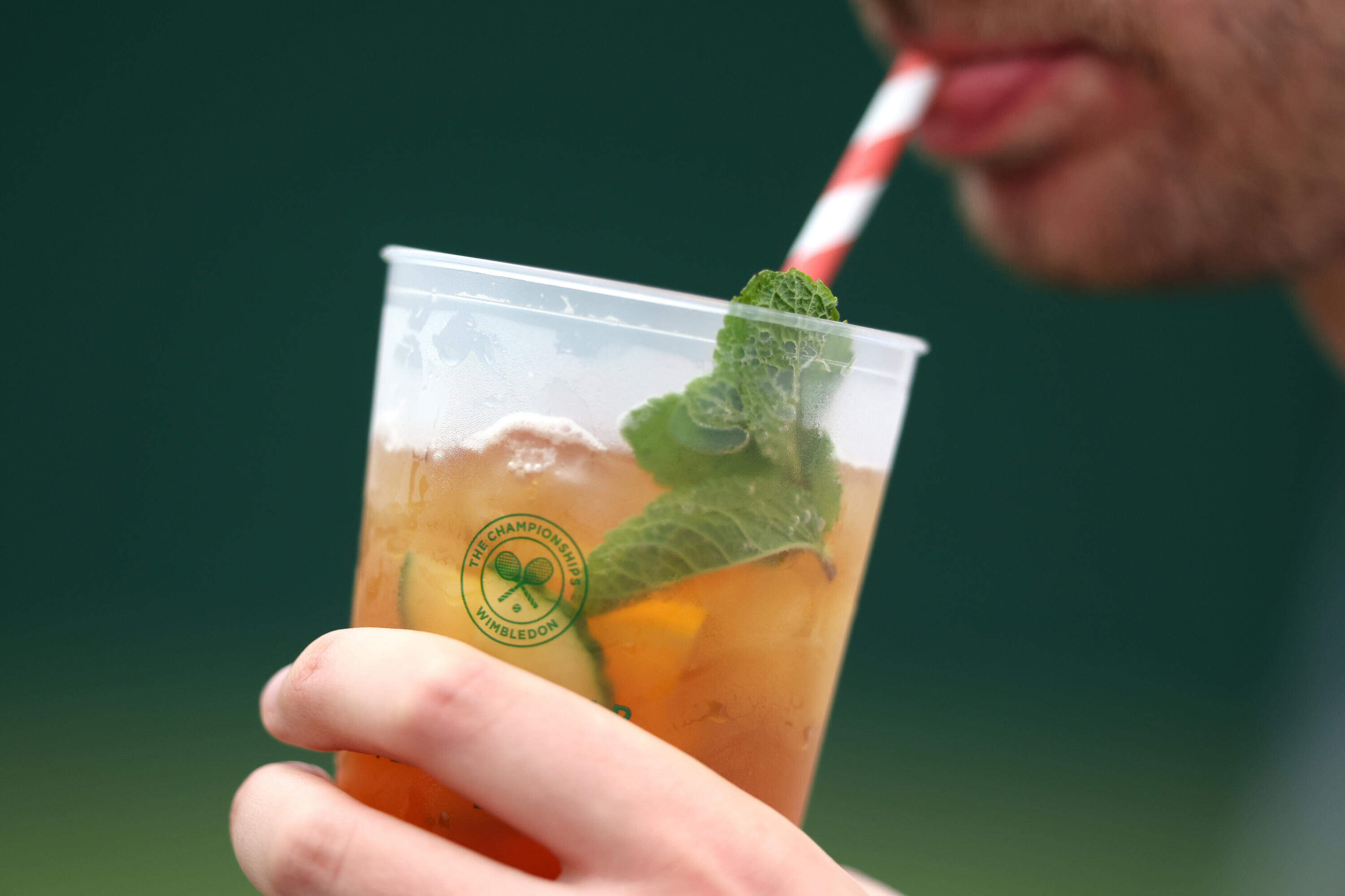 A spectator sips from a cup of Pimm's during day one of The Championships Wimbledon 2024 at All England Lawn Tennis and Croquet Club on July 01, 2024 in London, England. (Julian Finney/Getty Images)