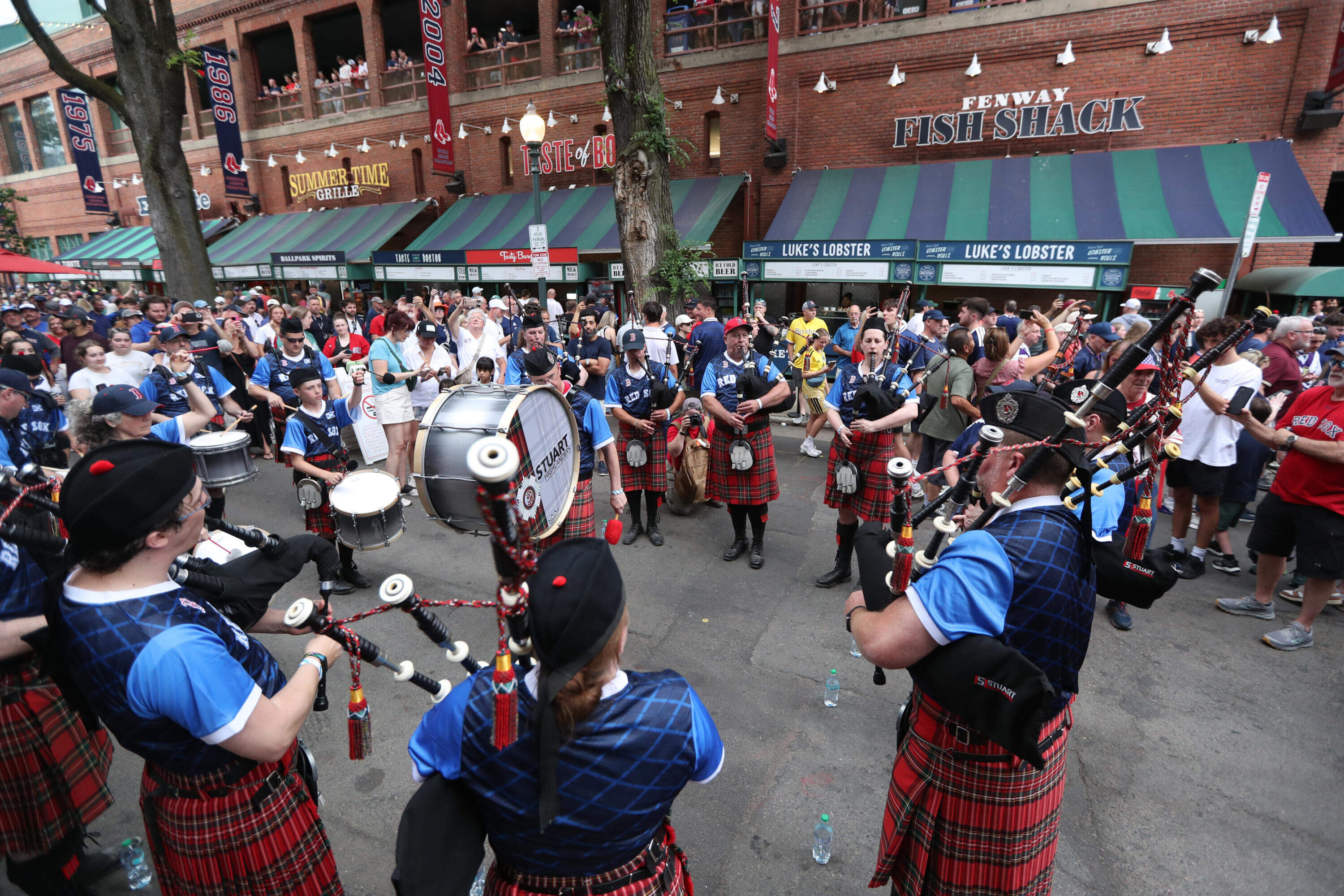 Members of the Tartan Army play bagpipes outside of Fenway Park before the game