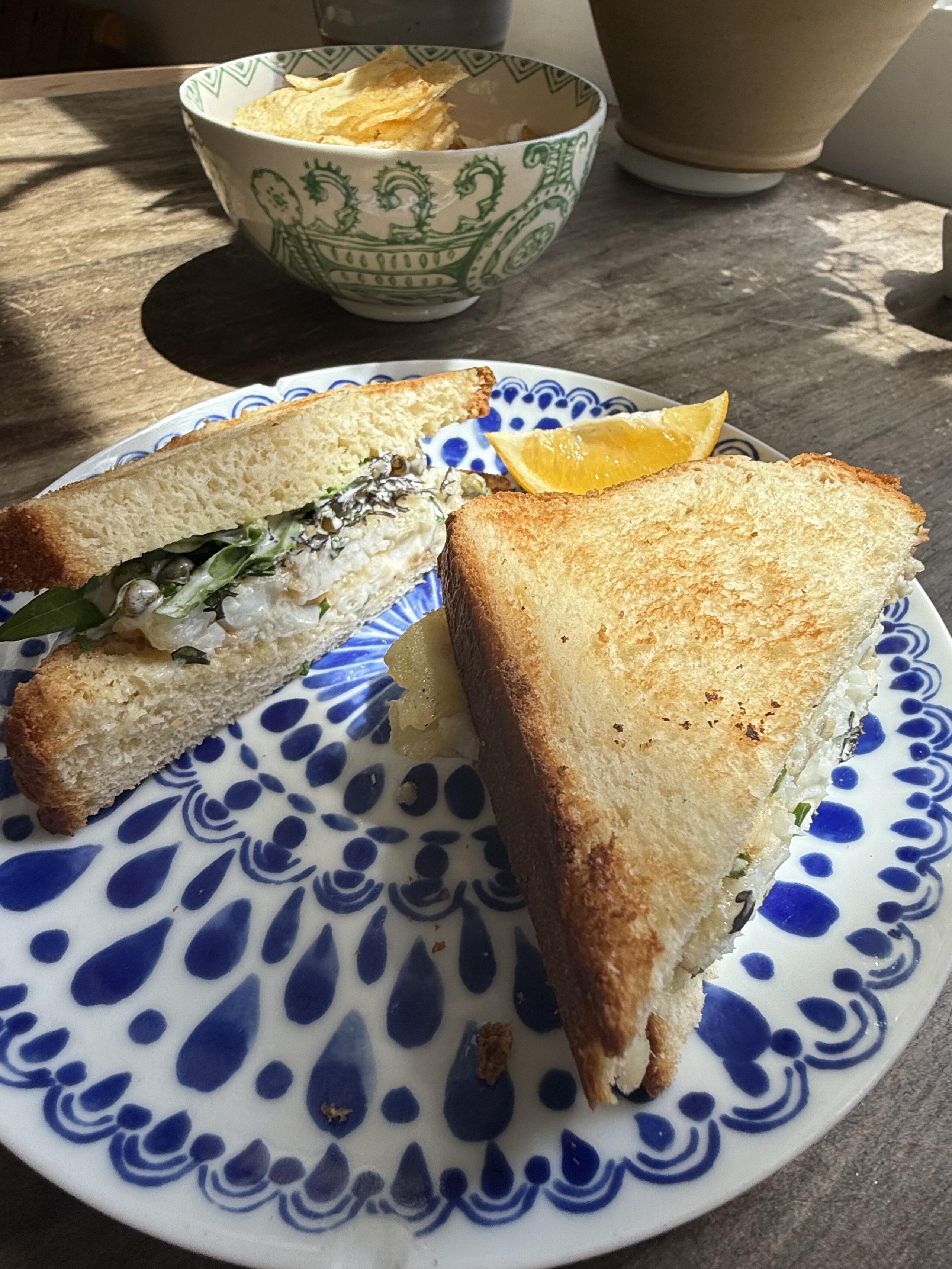 Fish sandwich with caper-pickle-lemon mayo. (Kathy Gunst/Here & Now)