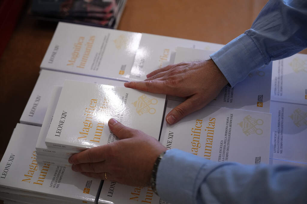Copies of Pope Leo XIV's first encyclical, "Magnifica humanitas: On Safeguarding the Human Person in the Time of Artificial Intelligence," are distributed at the Vatican, Monday, May 25, 2026. (AP Photo/Alessandra Tarantino)