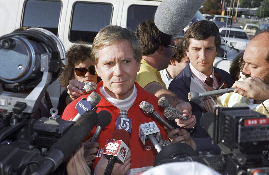 New England Patriot head coach Raymond Berry is surrounded by microphones, Oct. 15, 1987. (Carol Francavilla/AP)